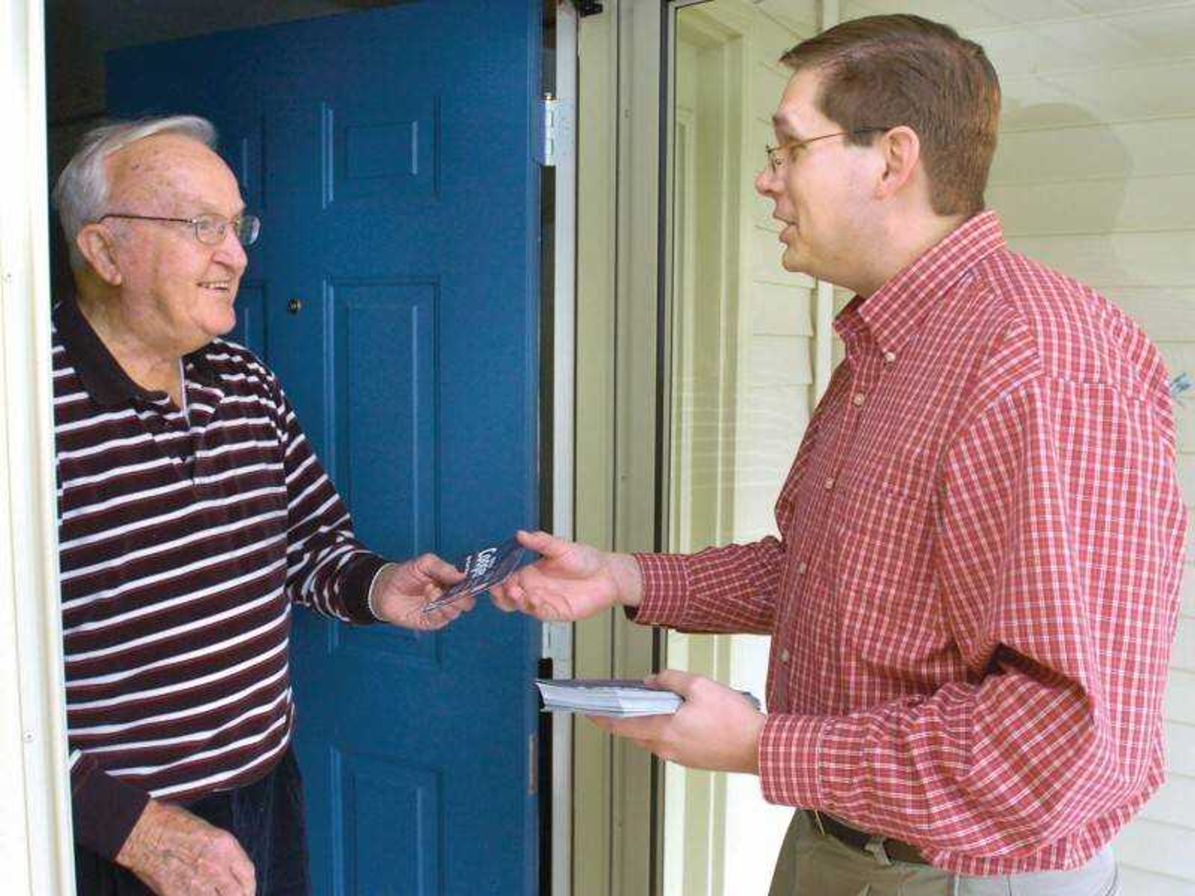 FRED LYNCH ~ flynch@semissourian.com
State rep. Nathan Cooper, right, visited Leonard Vogel while campaigning door to door in Cape Girardeau on Friday.