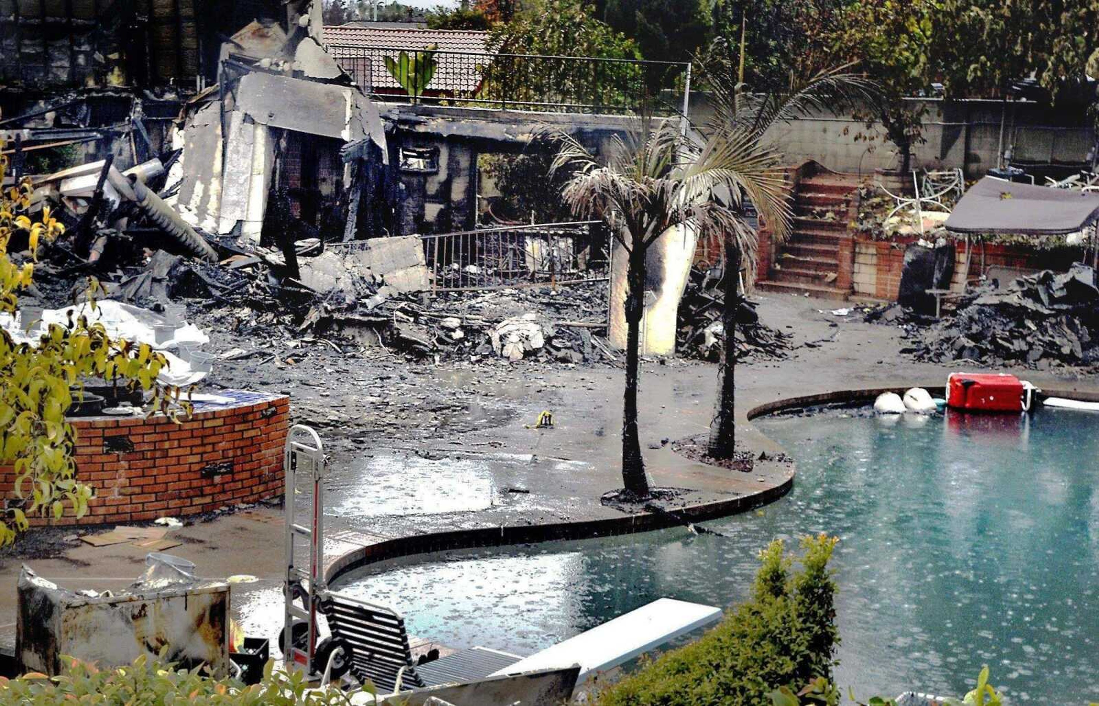 Watchara Phomicinda ~ San Gabriel Valley Tribune<br>The fire-damaged backyard of a house where a man carried out a Christmas Eve massacre is seen Thursday in Covina, Calif.