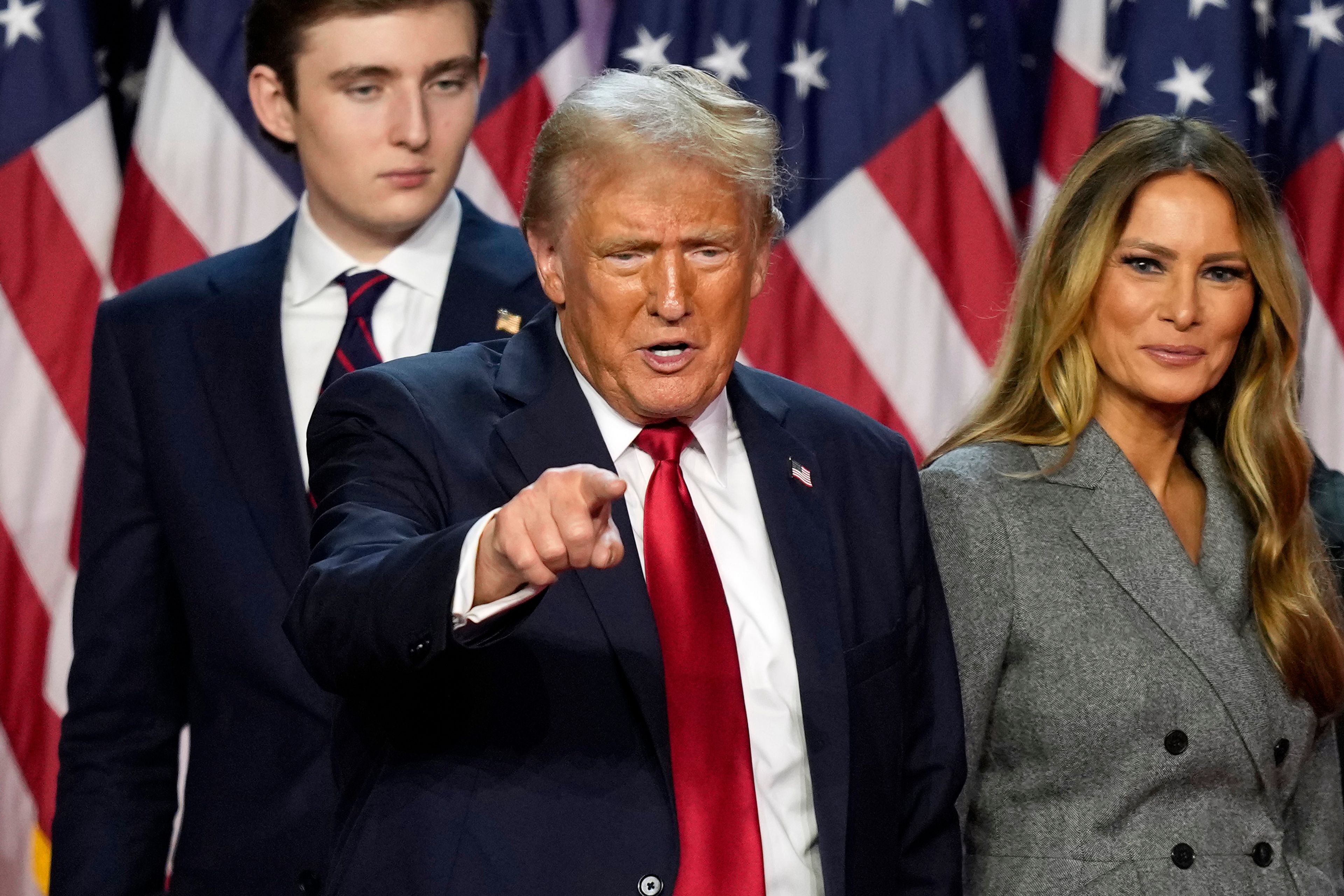 Republican presidential nominee former President Donald Trump departs as son Barron Trump, left, and former first lady Melania Trump look on at an election night watch party, Wednesday, Nov. 6, 2024, in West Palm Beach, Fla. (AP Photo/Alex Brandon)