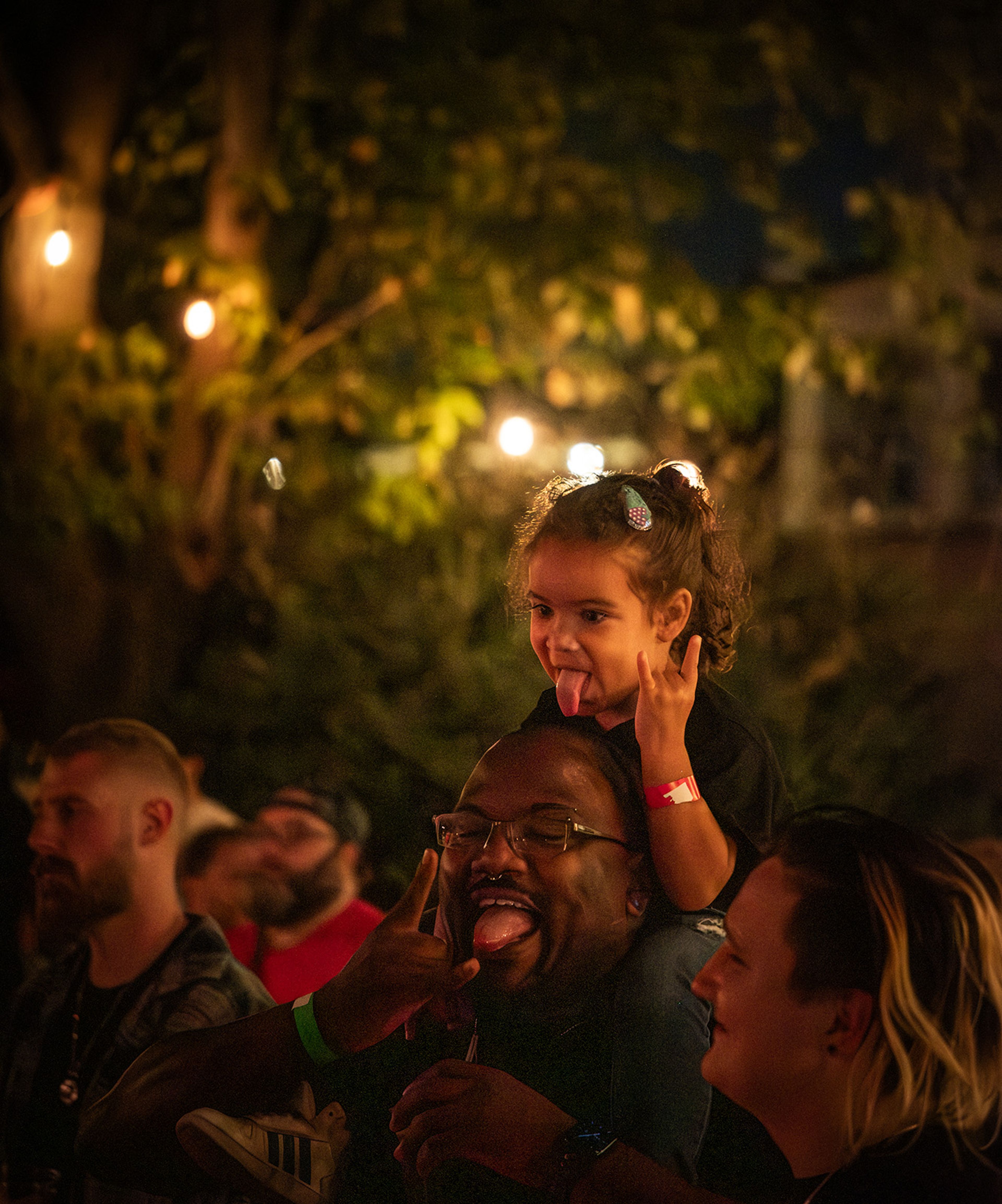 A family enjoys the atmosphere of Punktoberfest, embracing the community vibes.
