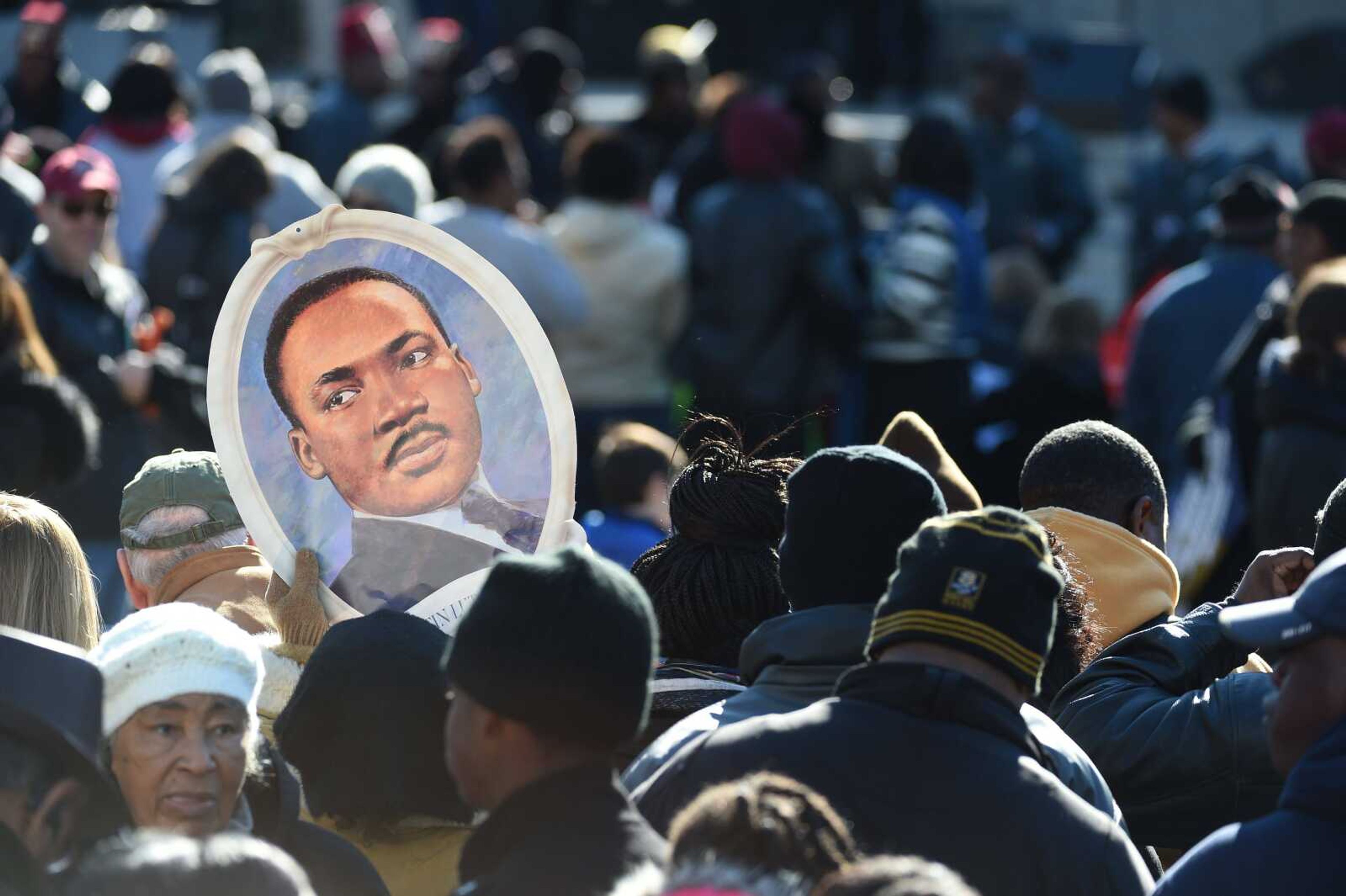 Attendees hold a portrait of Martin Luther King Jr. during the King Day at the Dome event Monday in Columbia, South Carolina. (Rainier Ehrhardt ~ Associated Press)