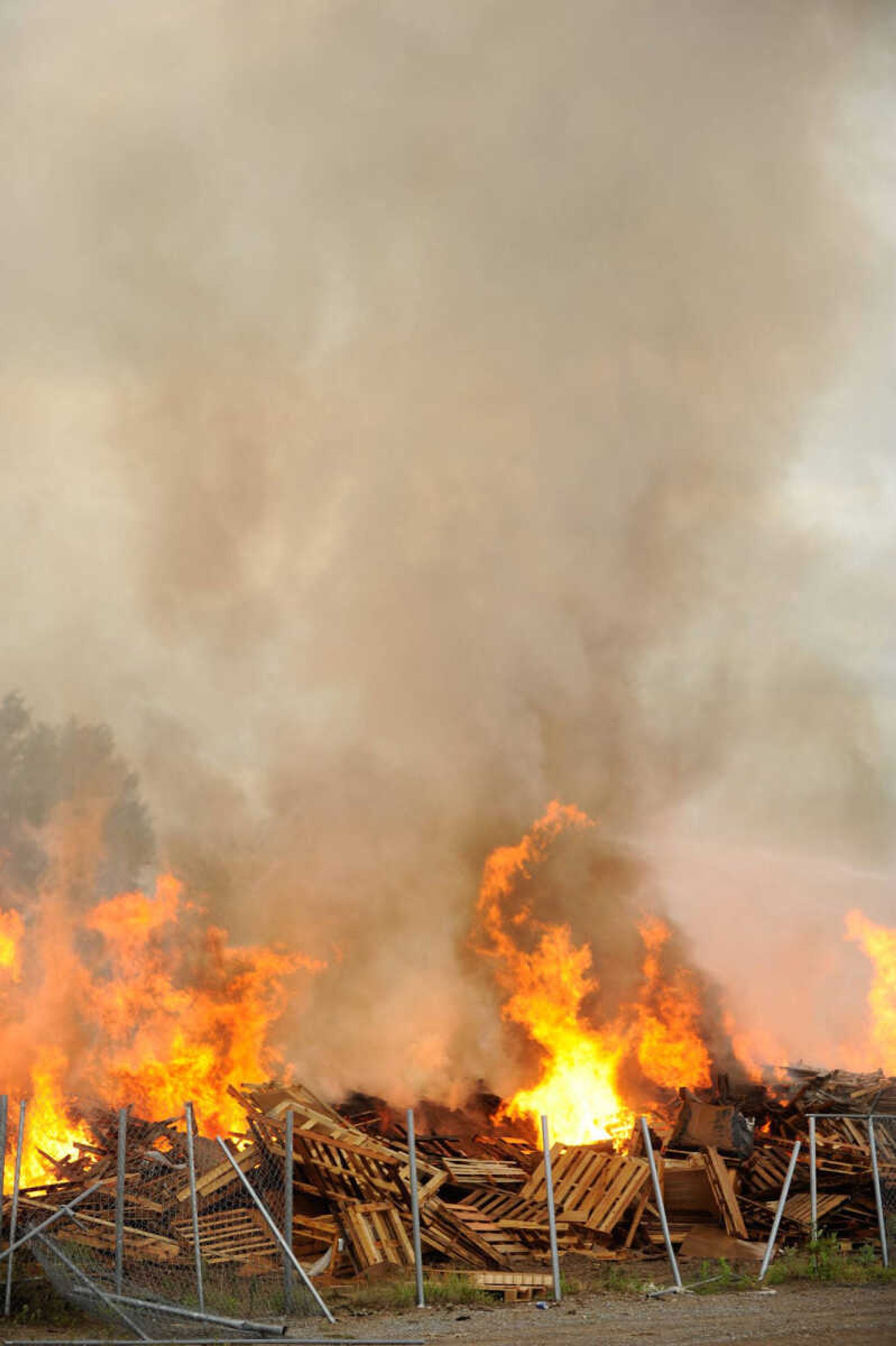 Several area fire departments work to extinguish a blaze Friday at Pallet Connections on Route H in Scott County. (Glenn Landberg)