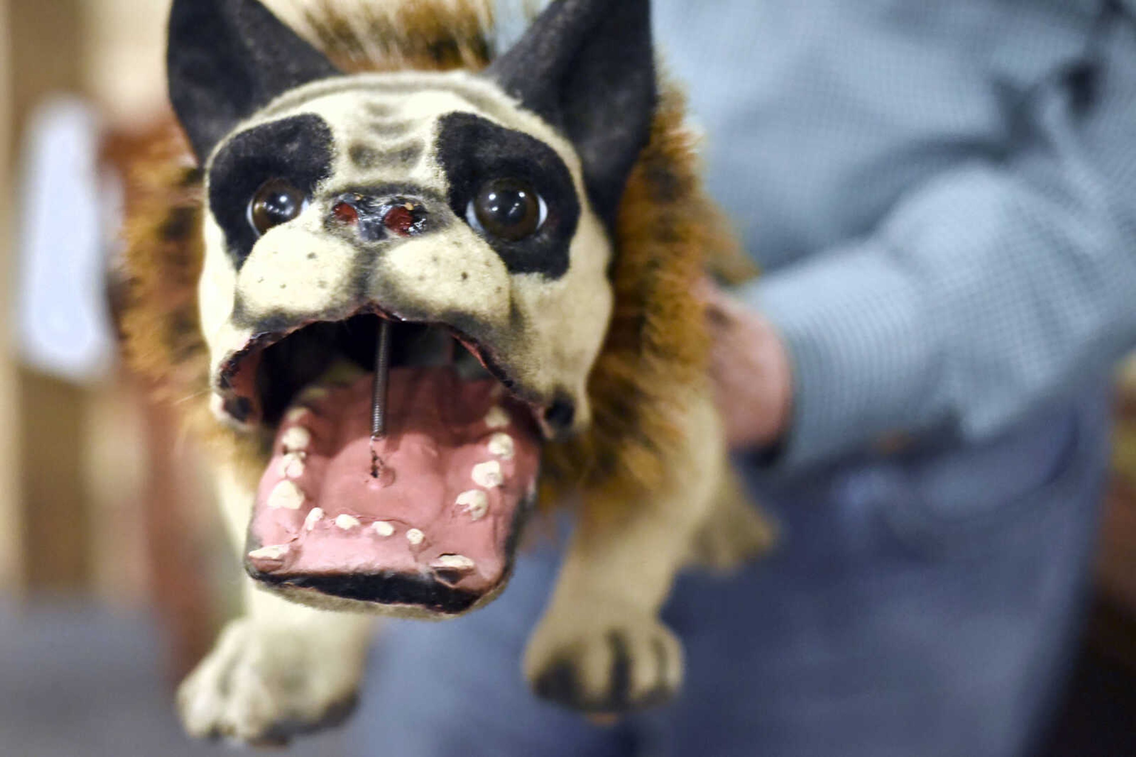 Harlan Smothers plays with an old toy dog Fat Chance General Store in Cape Girardeau County.