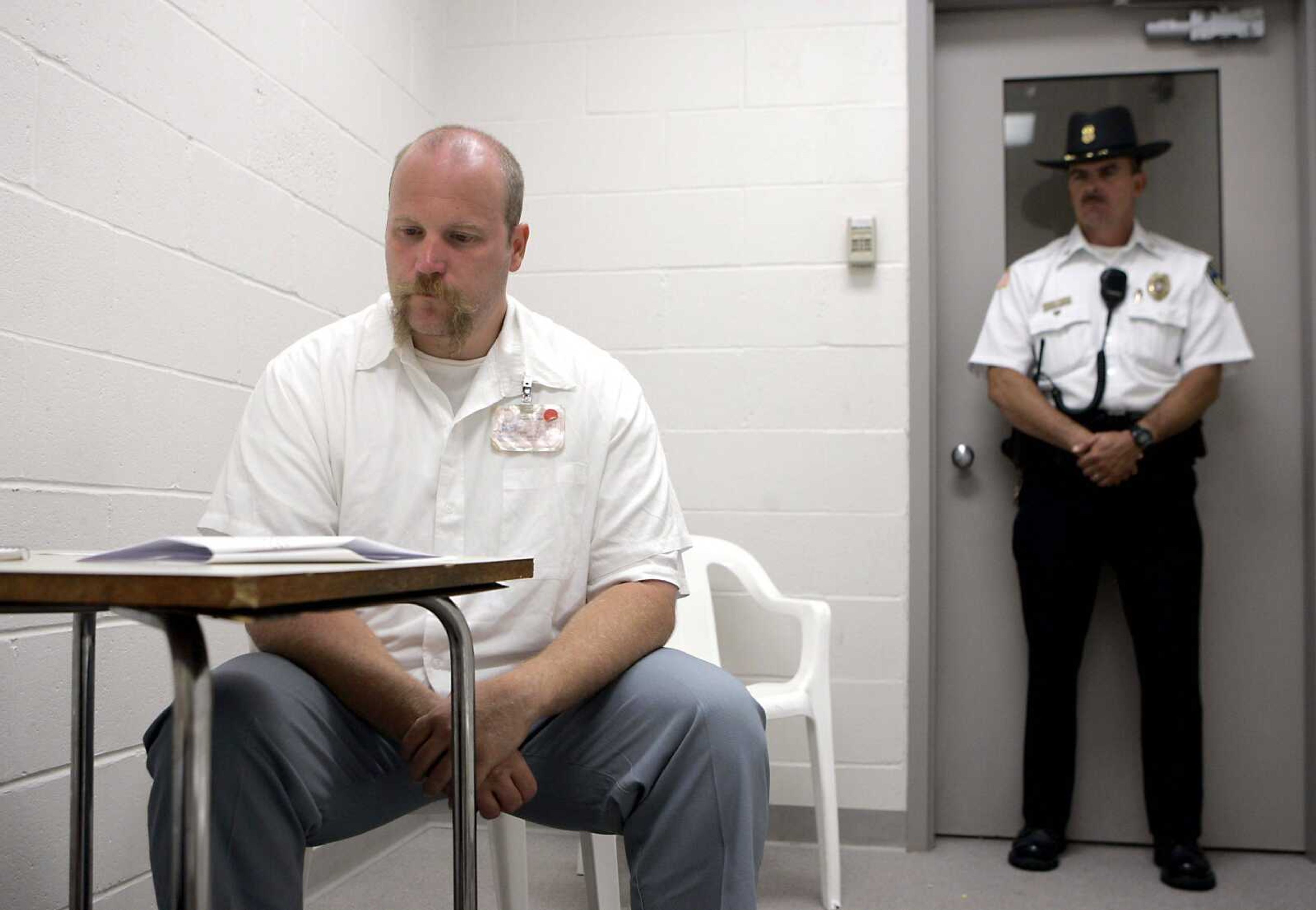 Missouri death row inmate Allen Nicklasson, left, pauses during an interview Aug. 14, 2008, as a guard stands nearby at the Potosi Correctional Center in Mineral Point, Mo. A panel of federal judges stayed Nicklasson&#8217;s execution late Monday, a little more than a day before he was set to die for killing Richard Drummond in 1994. (Jeff Robertson ~ Associated Press)