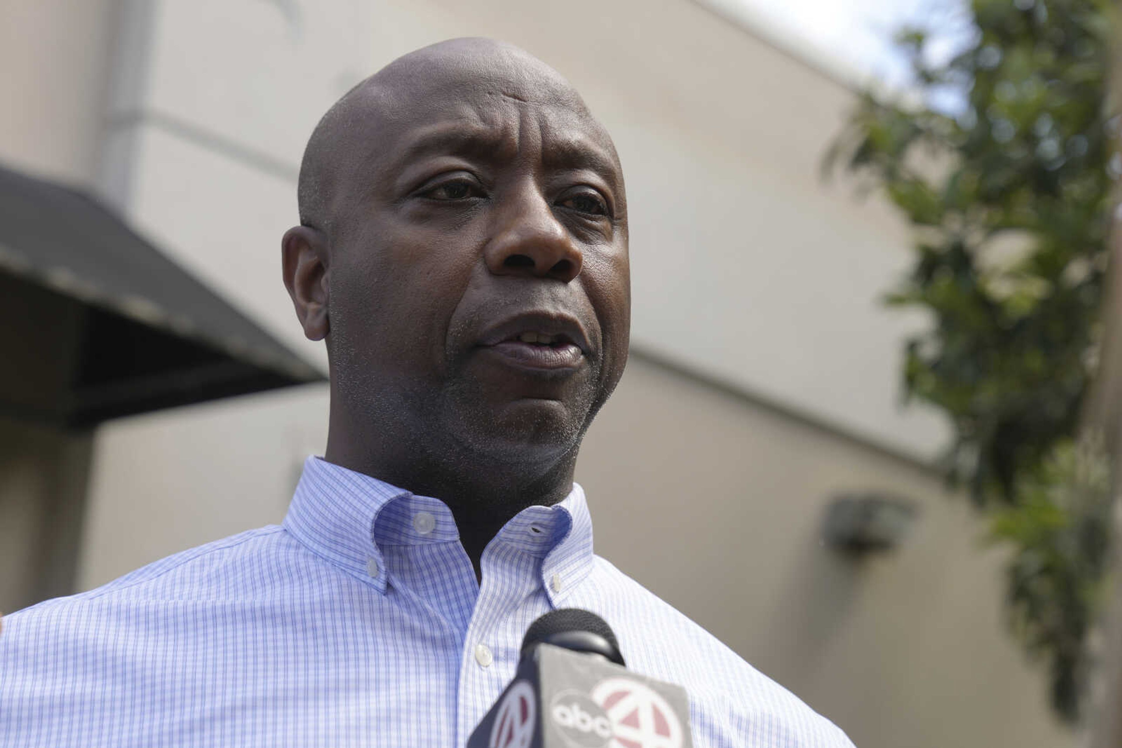 Sen. Tim Scott, R-S.C., speaks with reporters after a meet and greet on Friday in Goose Creek, South Carolina. Though he is not officially in the race, Scott launched his presidential exploratory committee last week, with an impressive $22 million sitting in the bank. If Scott follows through and formally joins the race, he will be entering with the largest campaign account balance of any contender in history.