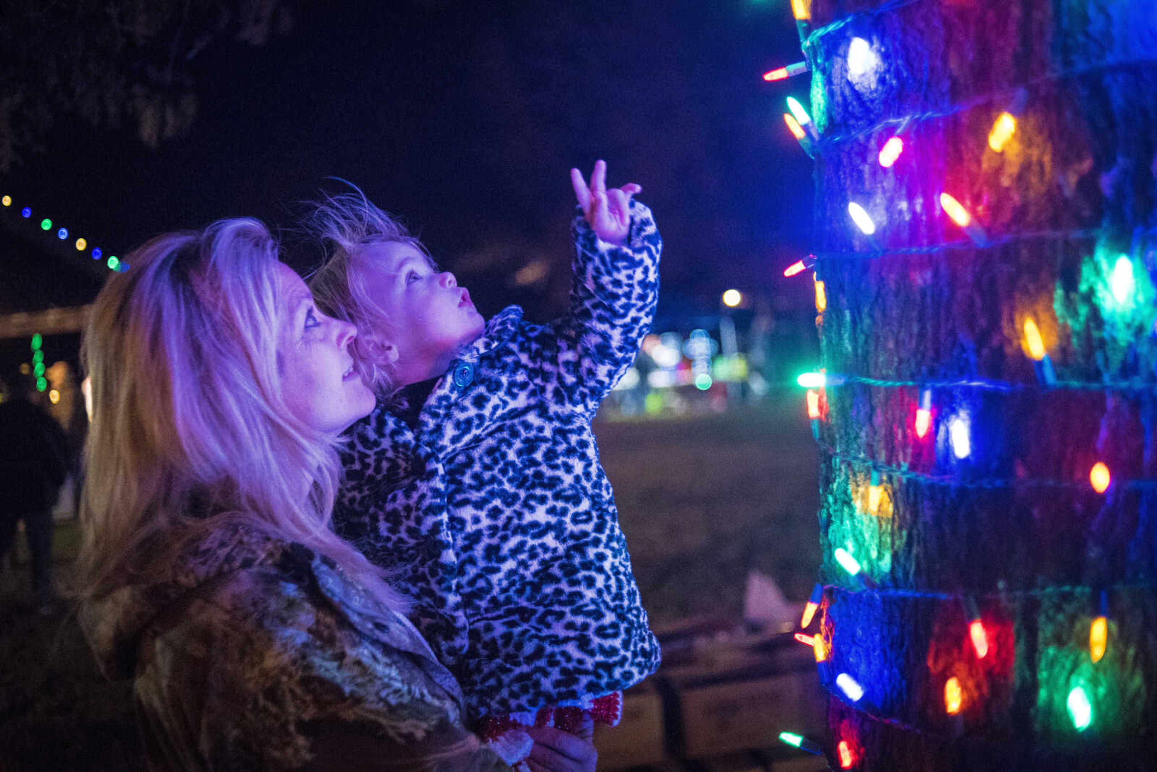 Joanie Presser, 1, and her grandmother Lynn Schreiner, look up at holiday lights during the Jackson Holiday Extravaganza Friday, Nov. 24, 2017 at the Jackson City Park.