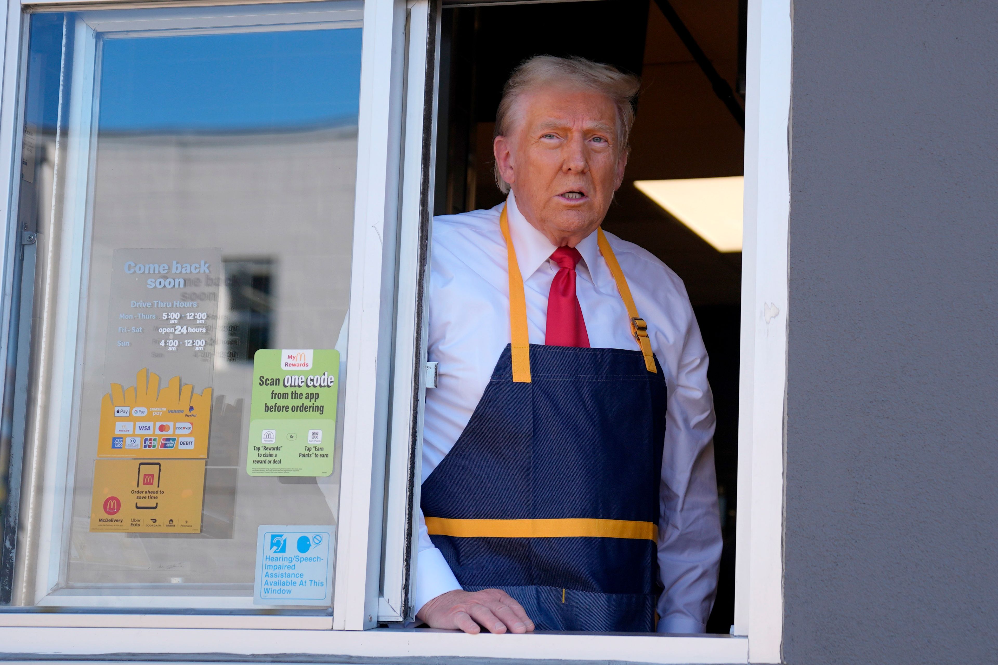 Republican presidential nominee former President Donald Trump stands at the drive-thru window during a campaign stop at a McDonald's, Sunday, Oct. 20, 2024, in Feasterville-Trevose, Pa. (AP Photo/Evan Vucci)