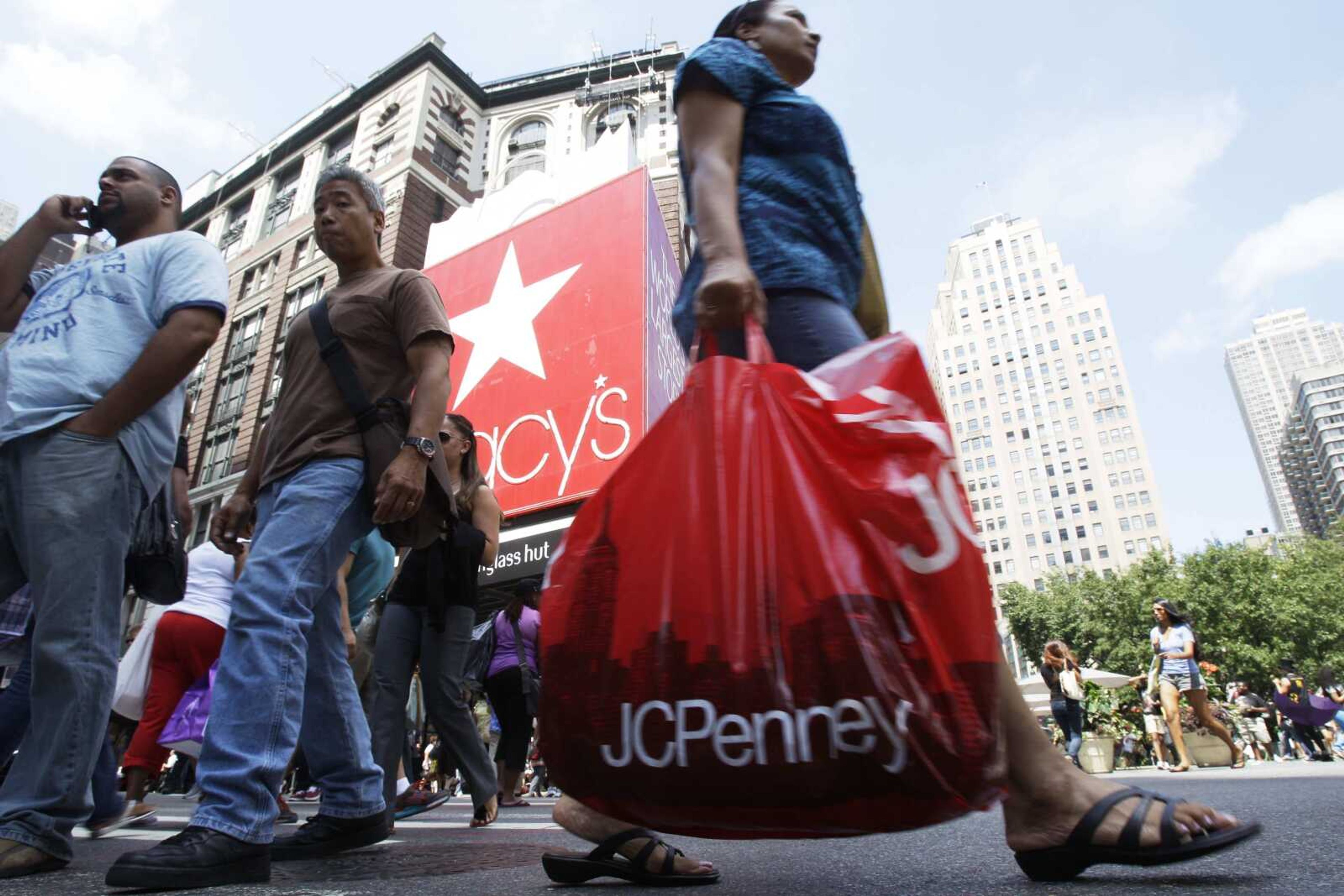 Shoppers pass Macy's department store in New York on Aug. 4. Retailers are raising prices on merchandise an average of 10 percent this fall in an effort to offset rising costs. (Frank Franklin II ~ Associated Press)