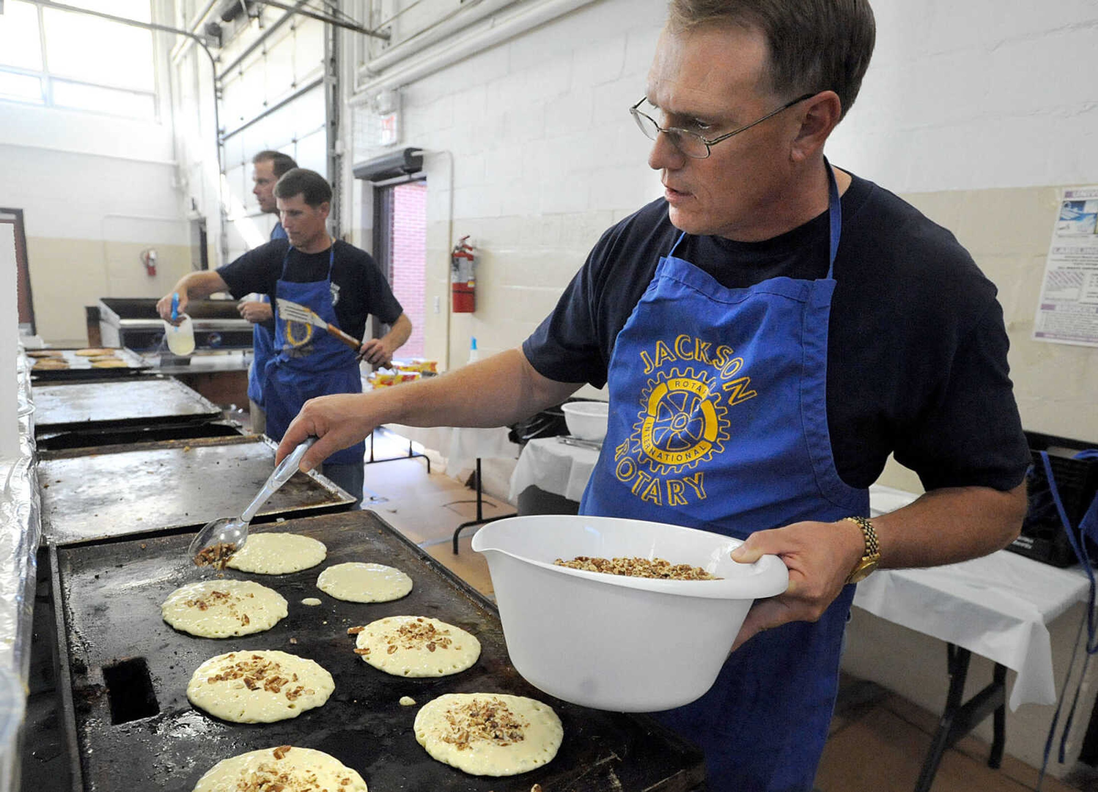 LAURA SIMON ~ lsimon@semissourian.com
Matt Puchbauer adds crushed pecans to pancakes on the griddle Tuesday, Oct. 23, 2012 during the Jackson Rotary Pancake Day at the National Guard Armory. People could pick from plain, chocolate chip, pecan and blueberry pancakes and a side of sausage.