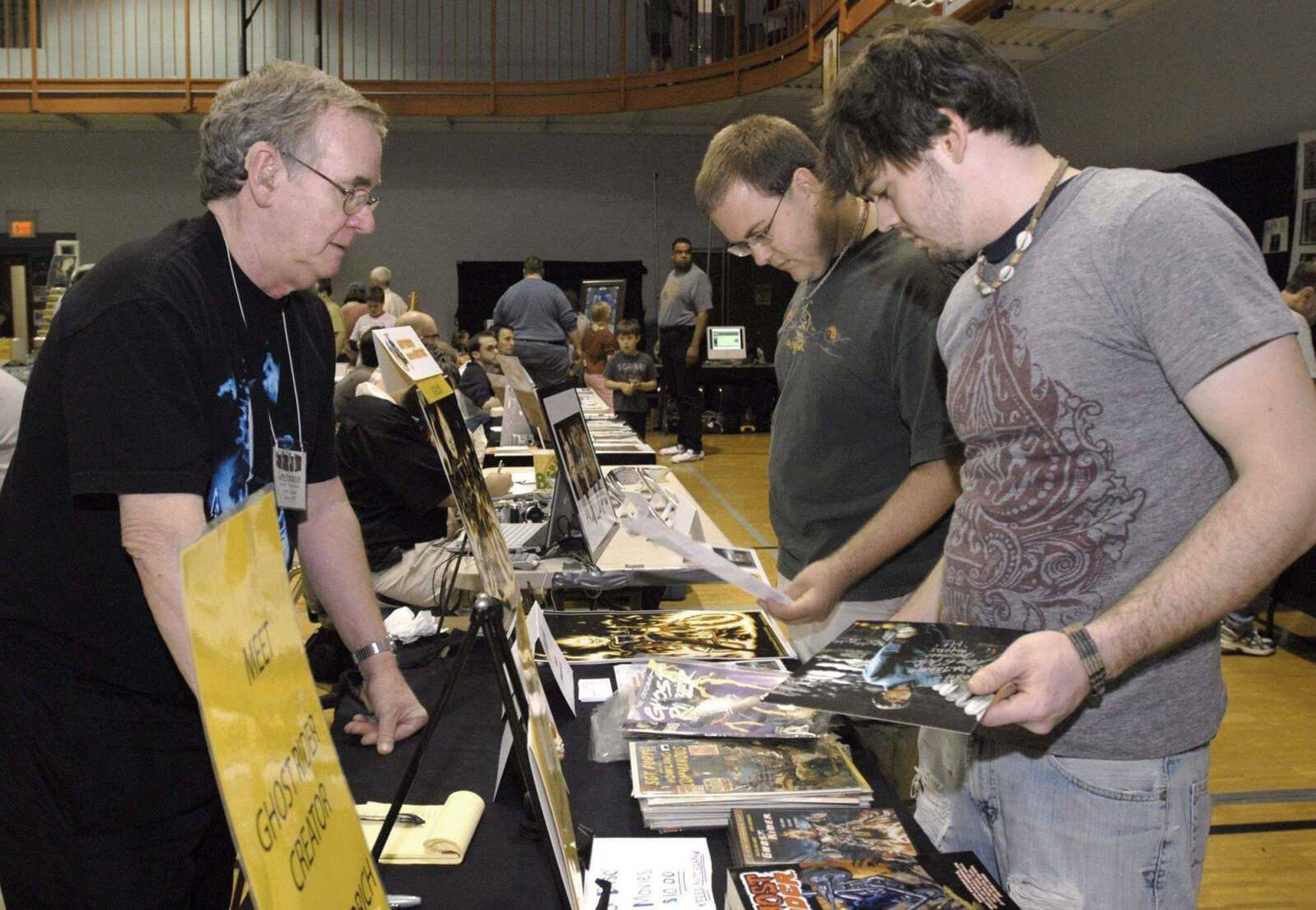 Ghost Rider creator Gary Friedrich, left, operates a table in April 2008 at Cape Comic Con, which attracted Daniel Bryant, center, and Josh Wiseman, who bought an autographed "Ghost Rider" comic book.