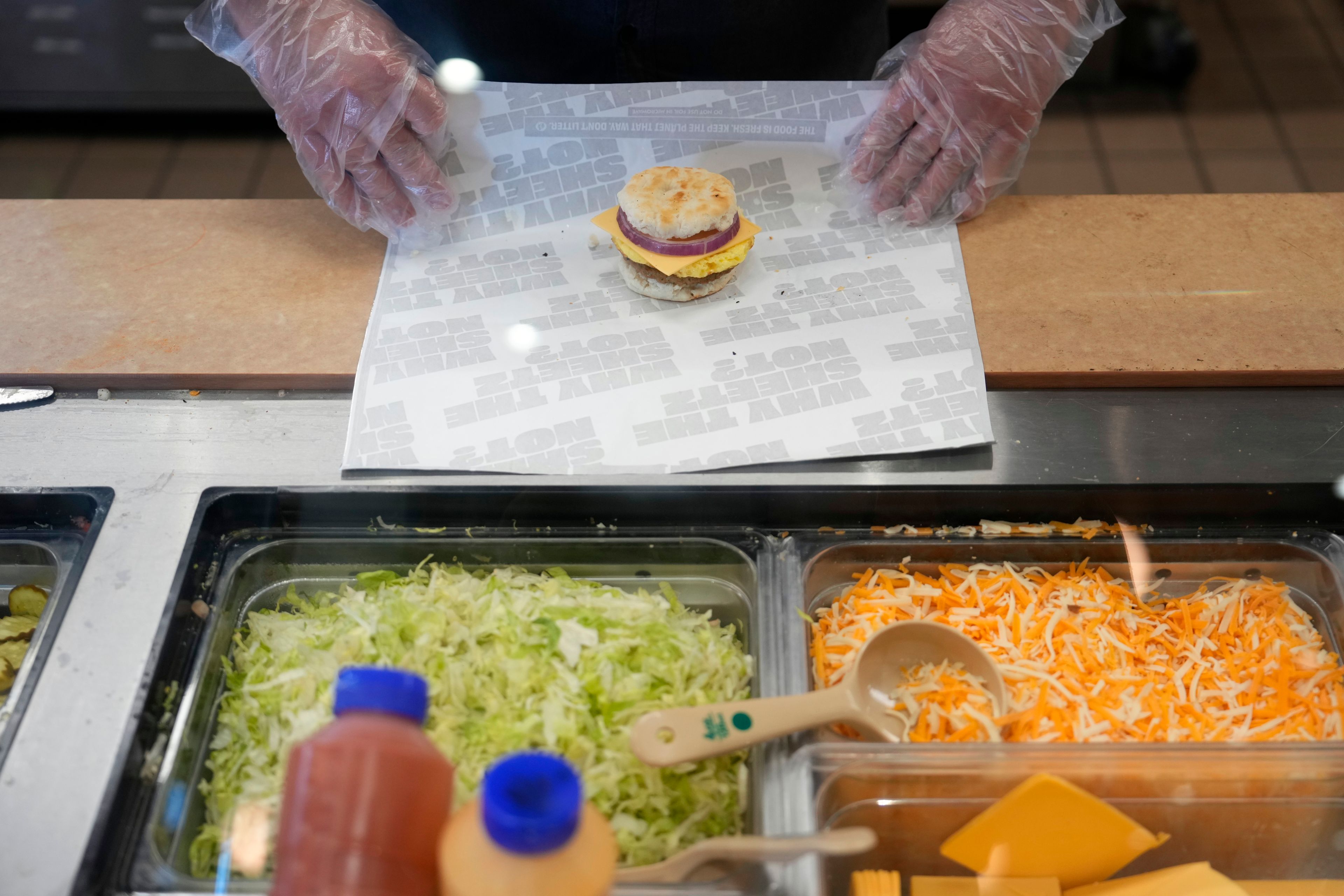 Sheetz employee Dylan Sachs prepares a breakfast sandwich at the convenience store, Thursday, Oct. 17, 2024, in Bethlehem, Pa. (AP Photo/Matt Slocum)