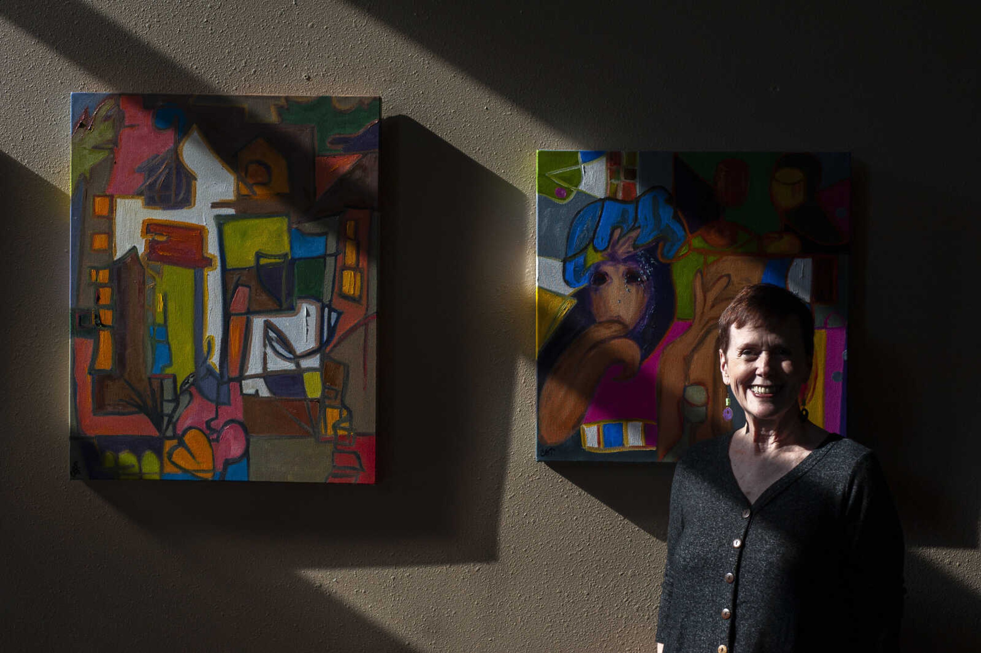 Local artist Caroline Thompson, originally of Kennett, Missouri, and now Cape Girardeau, poses for a portrait with some of her artwork Tuesday, Nov. 19, 2019, at her home in Cape Girardeau. The painter got her start in the craft in 1999.