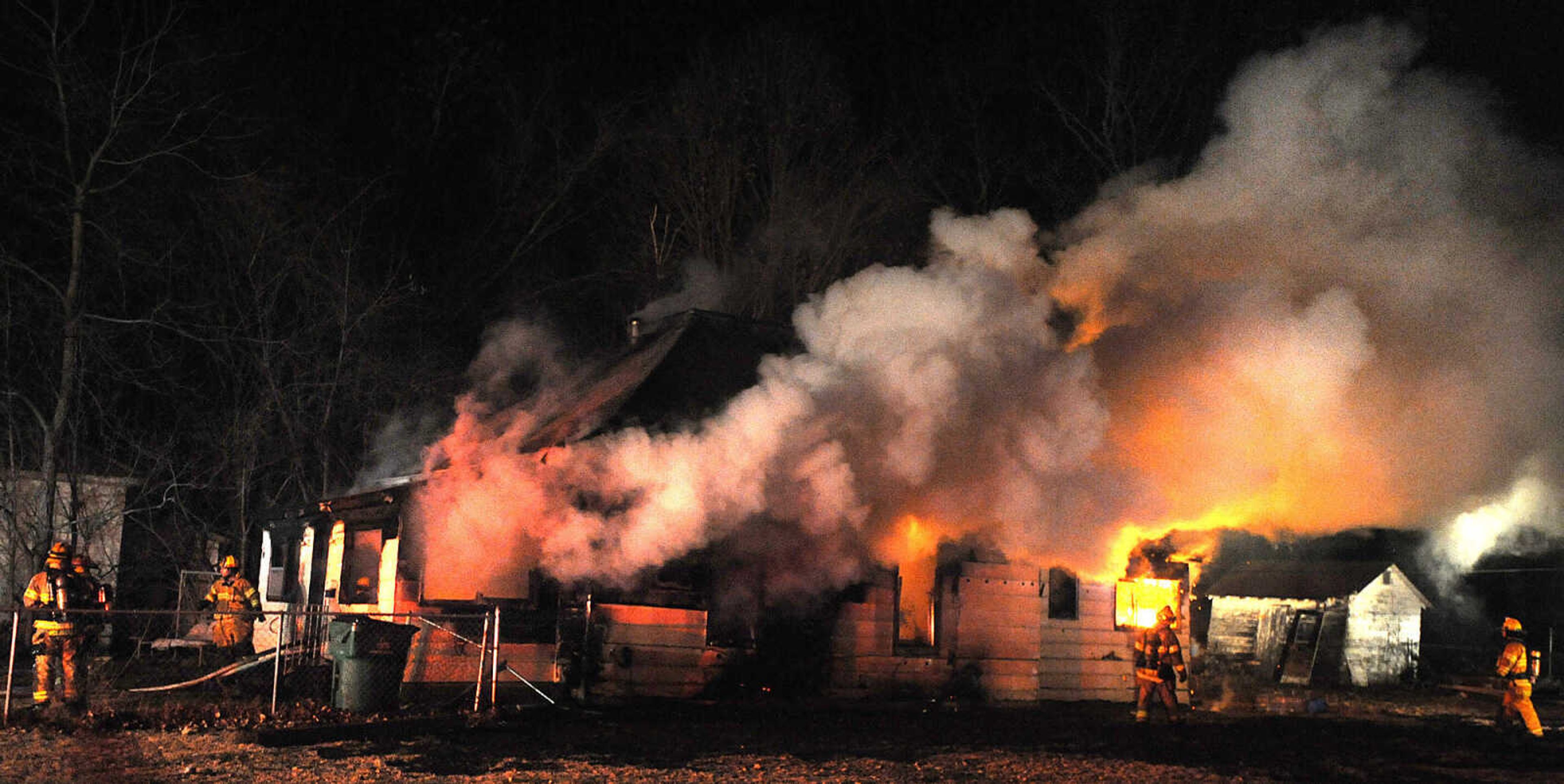 LAURA SIMON ~ lsimon@semissourian.com

Members of the Scott City and Cape Girardeau fire departments battle a blaze at 308 W. Missouri Blvd. in Scott City, Wednesday, Dec. 18, 2013. Nobody was injured in the fire.