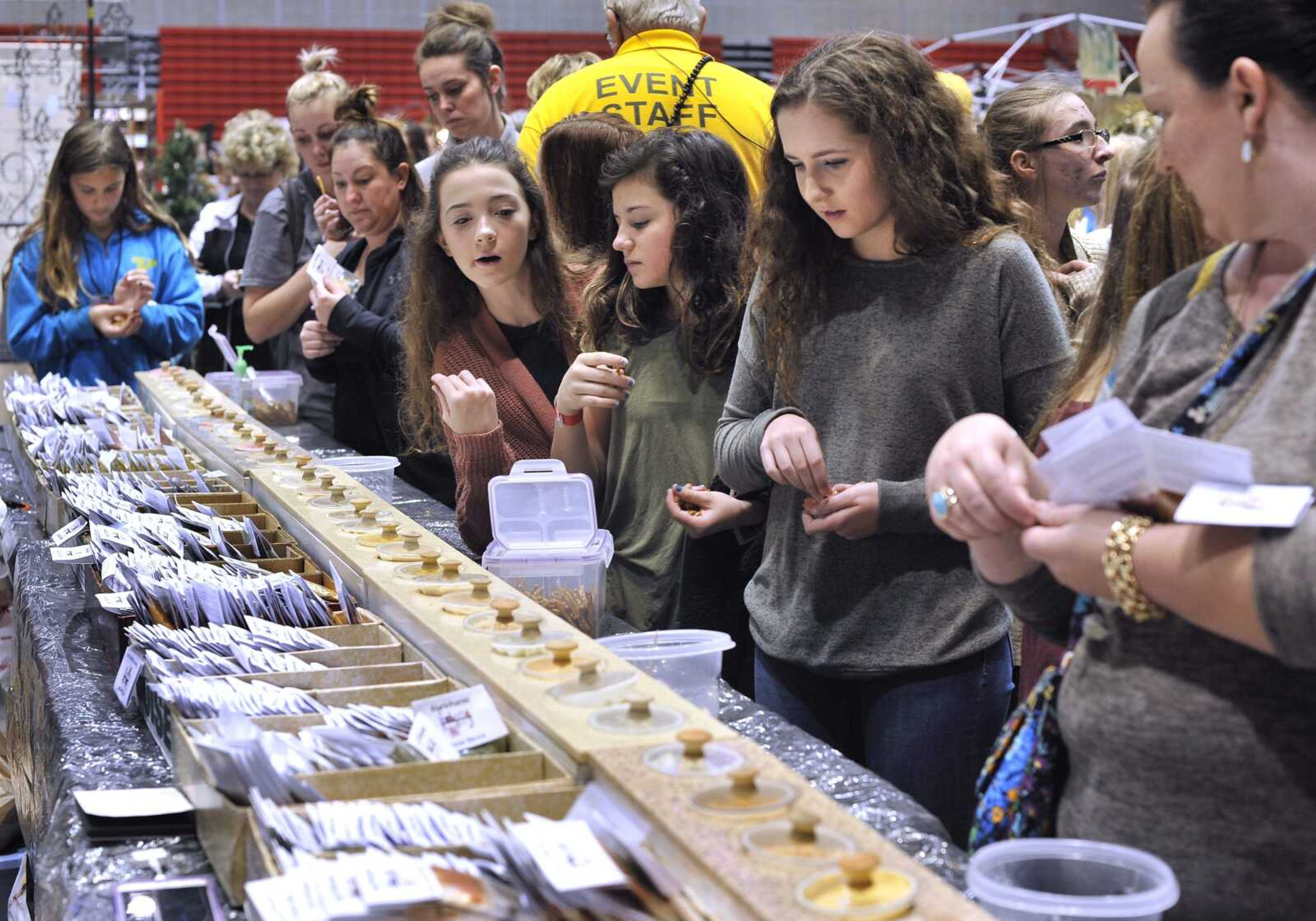 People taste samples of dips offered by Pam's Pantry at the Arts and Crafts Extravaganza on Nov. 18, 2017, at the Show Me Center in Cape Girardeau.