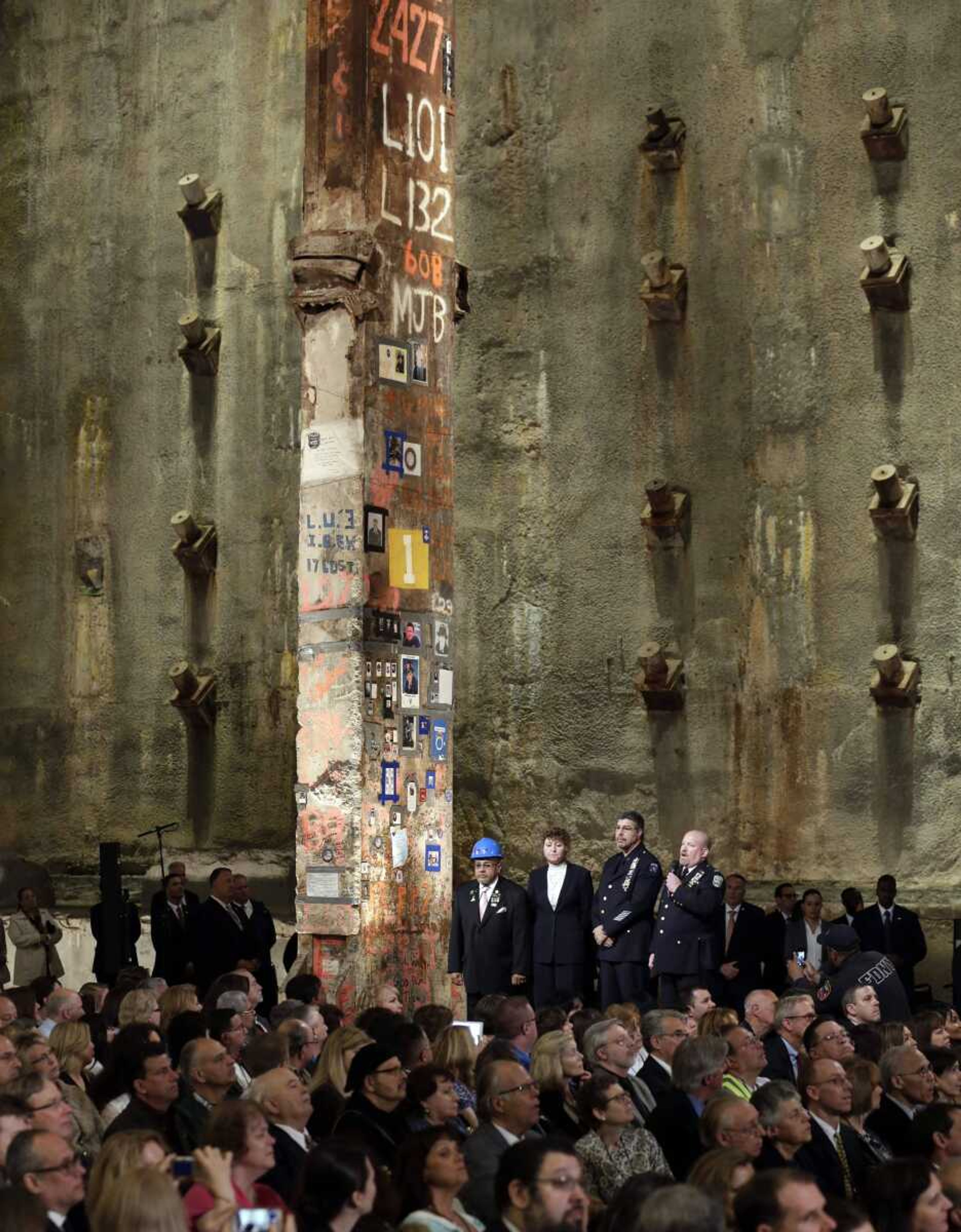 Recovery workers Manny Rodriguez, Pia Hofmann, Detective Anthony Favara and Lt. Stephen Butler speak beside the symbolic World Trade Center final beam during the dedication ceremony Thursday in Foundation Hall of the National September 11 Memorial and Museum in New York. (Richard Drew ~ Associated Press)