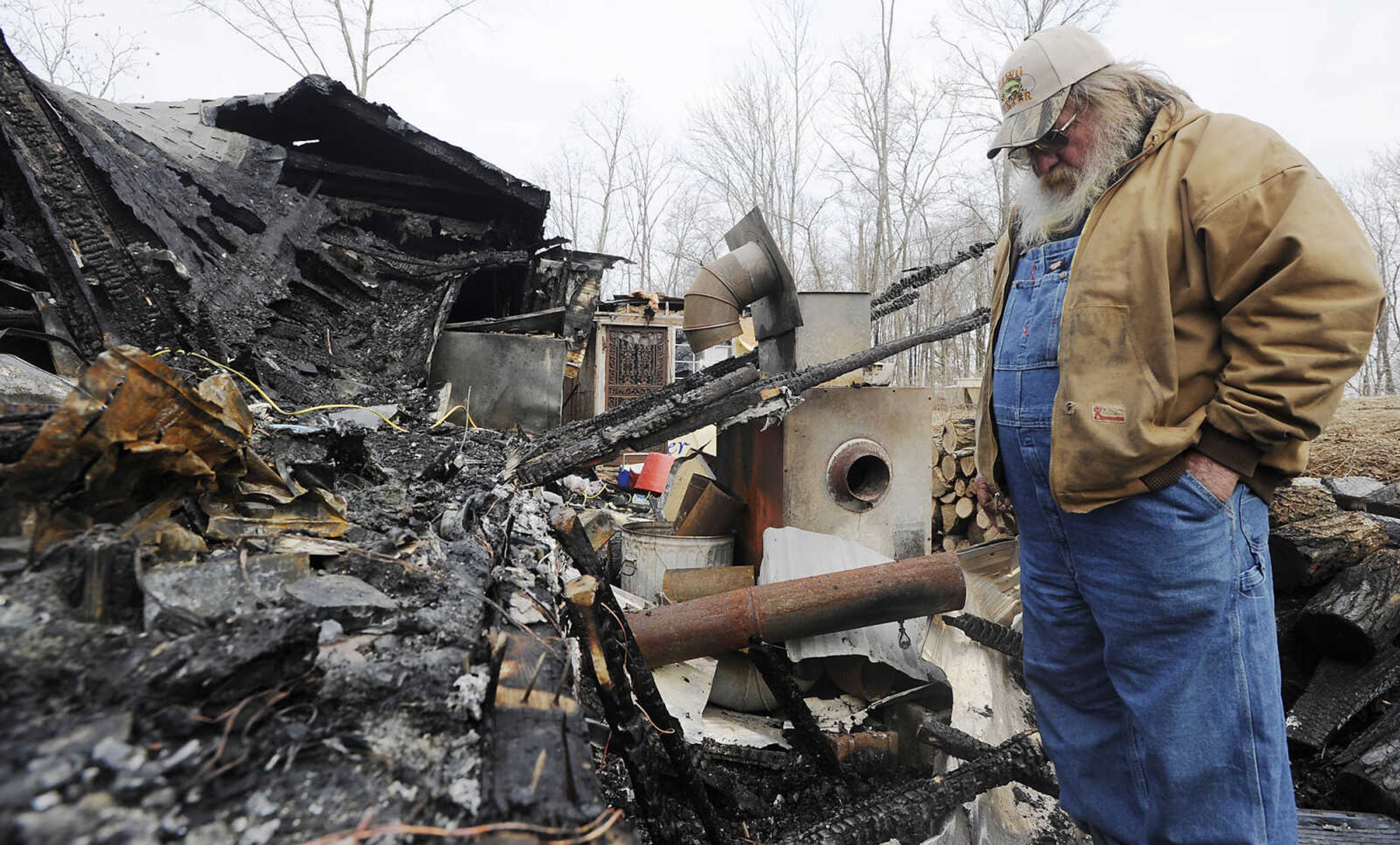 ADAM VOGLER ~ avogler@semissourian.com
Harry Matlock look at the burnt remains of the home he shared with his wife Linda, their daughter Deanne Baine and her daughters Brittany and Sommer Gerber Friday, Jan. 25. An accidental fire destroyed the house Monday, Jan. 21. The family is now living in a recreational vehicle on the property.