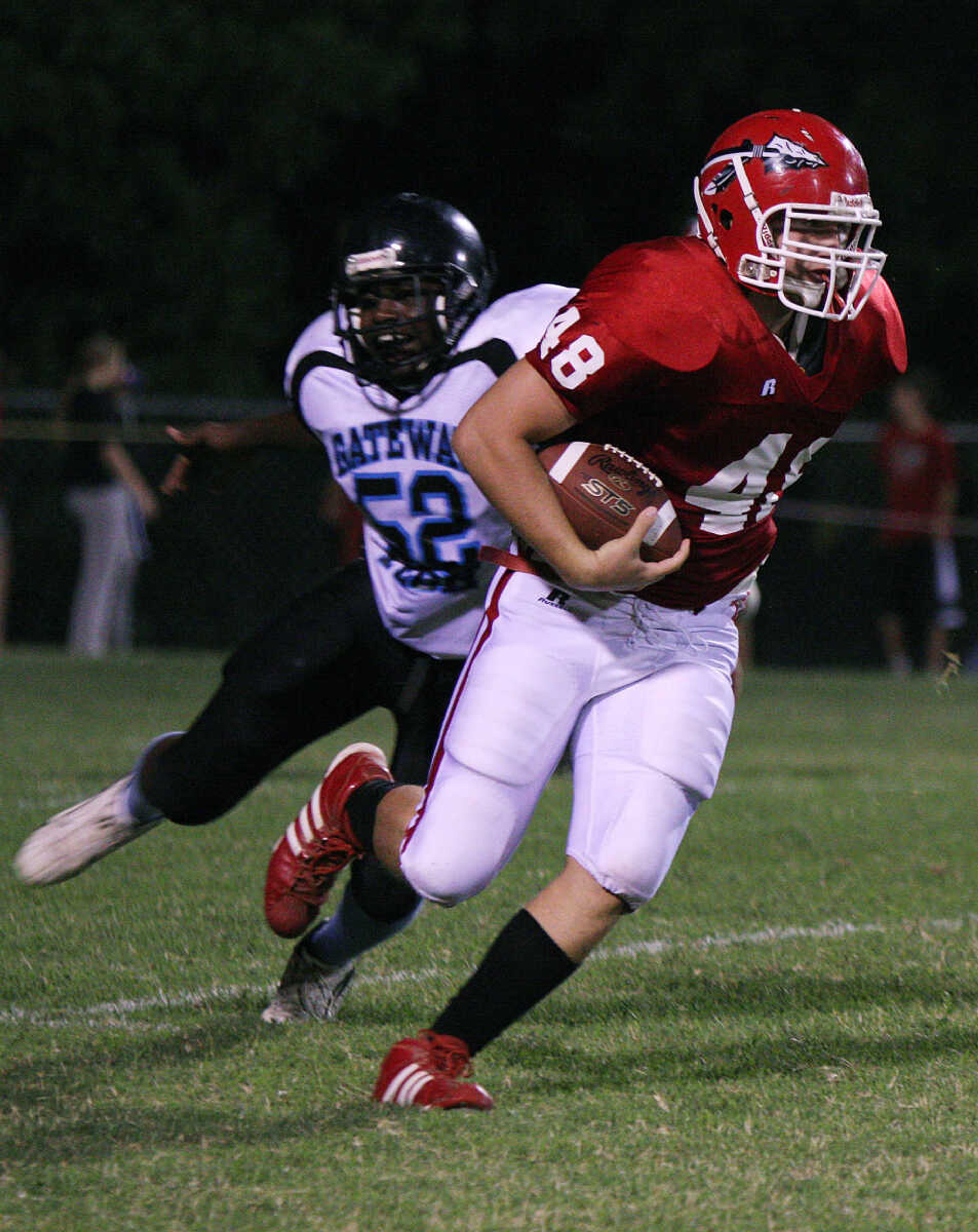 Jackson's Eli Gohn brushes off defender Terrion Latimore after catching a pass.