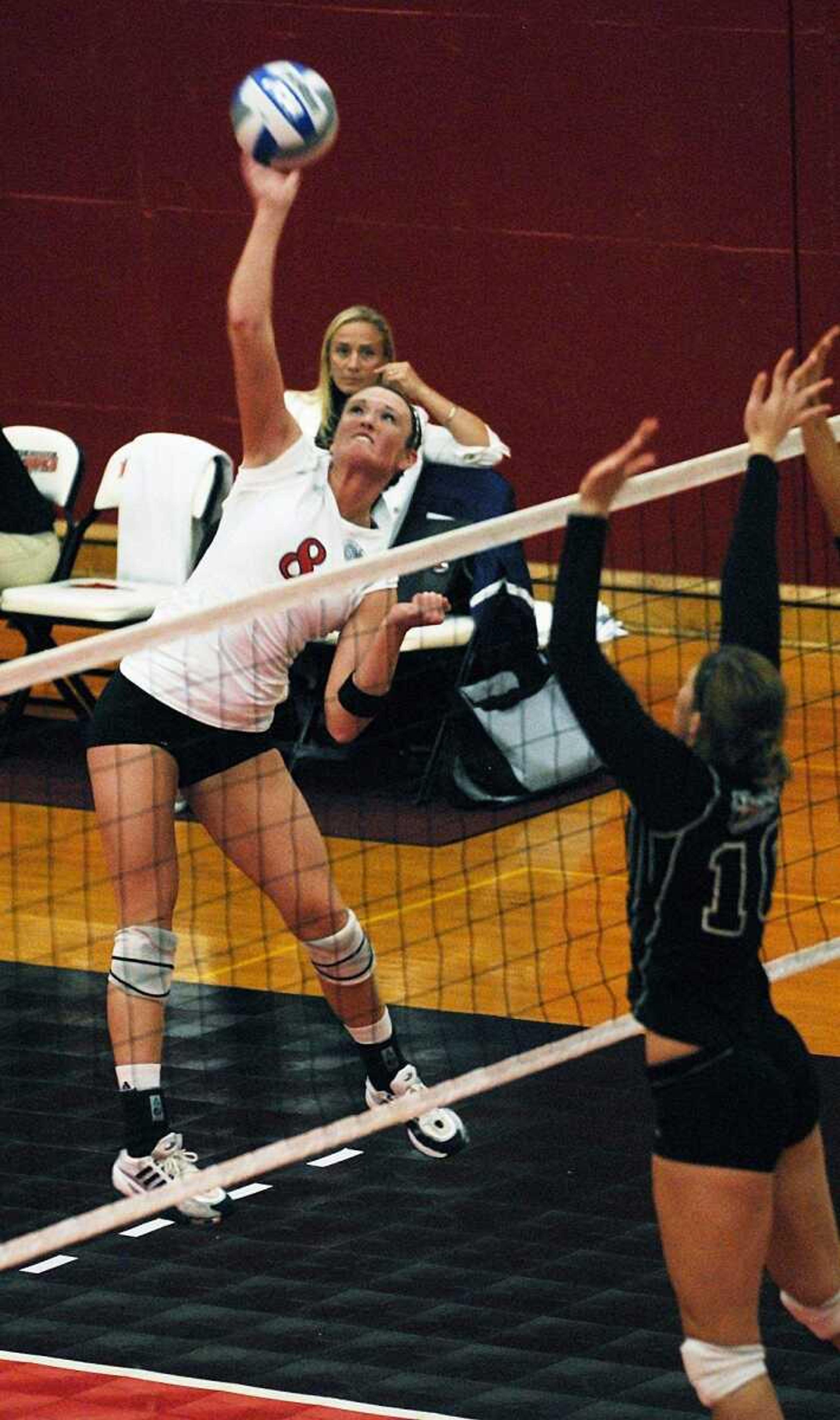 CHUCK WU ~ cwu@semissourian.com
SEMO's Claire Keaton spikes the ball as coach Renata Nowacki looks on.