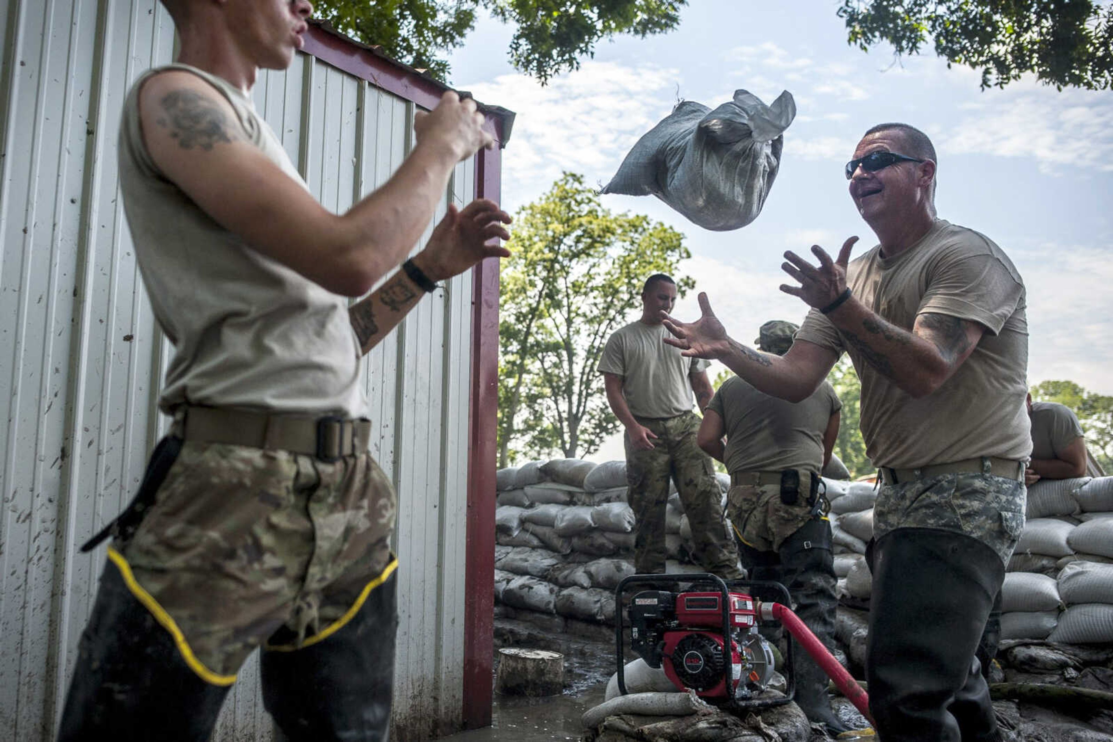 National Guardsmen work to repair a sandbag wall July 18 after high winds the night before had damaged a portion of the barrier near a home in East Cape Girardeau, Illinois. Well over 250,000 sandbags were used in Alexander County in the East Cape Girardeau and McClure areas, according to an Illinois official.