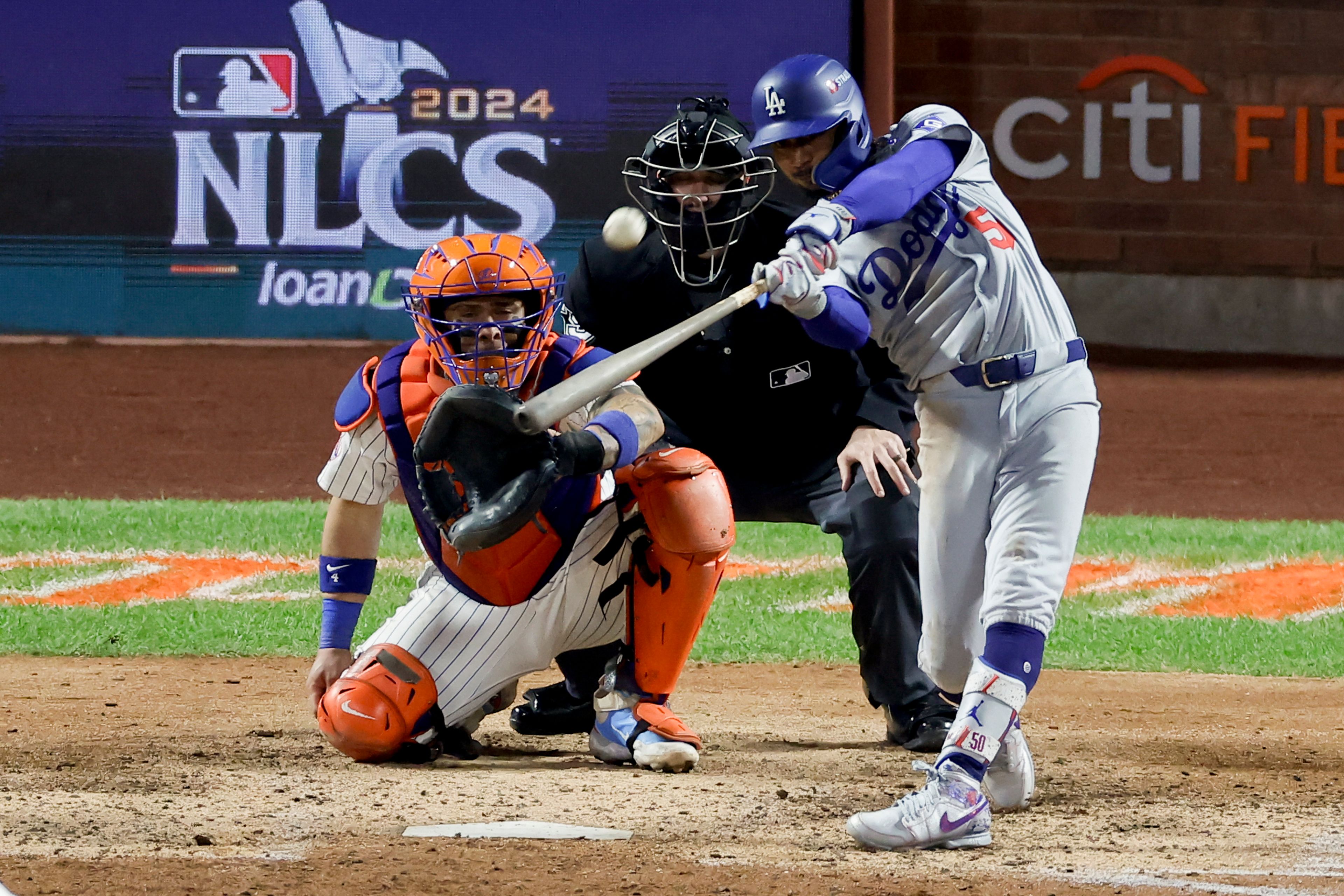 Los Angeles Dodgers' Mookie Betts hits a two-run home run against the New York Mets during the sixth inning in Game 4 of a baseball NL Championship Series, Thursday, Oct. 17, 2024, in New York (AP Photo/Adam Hunger)