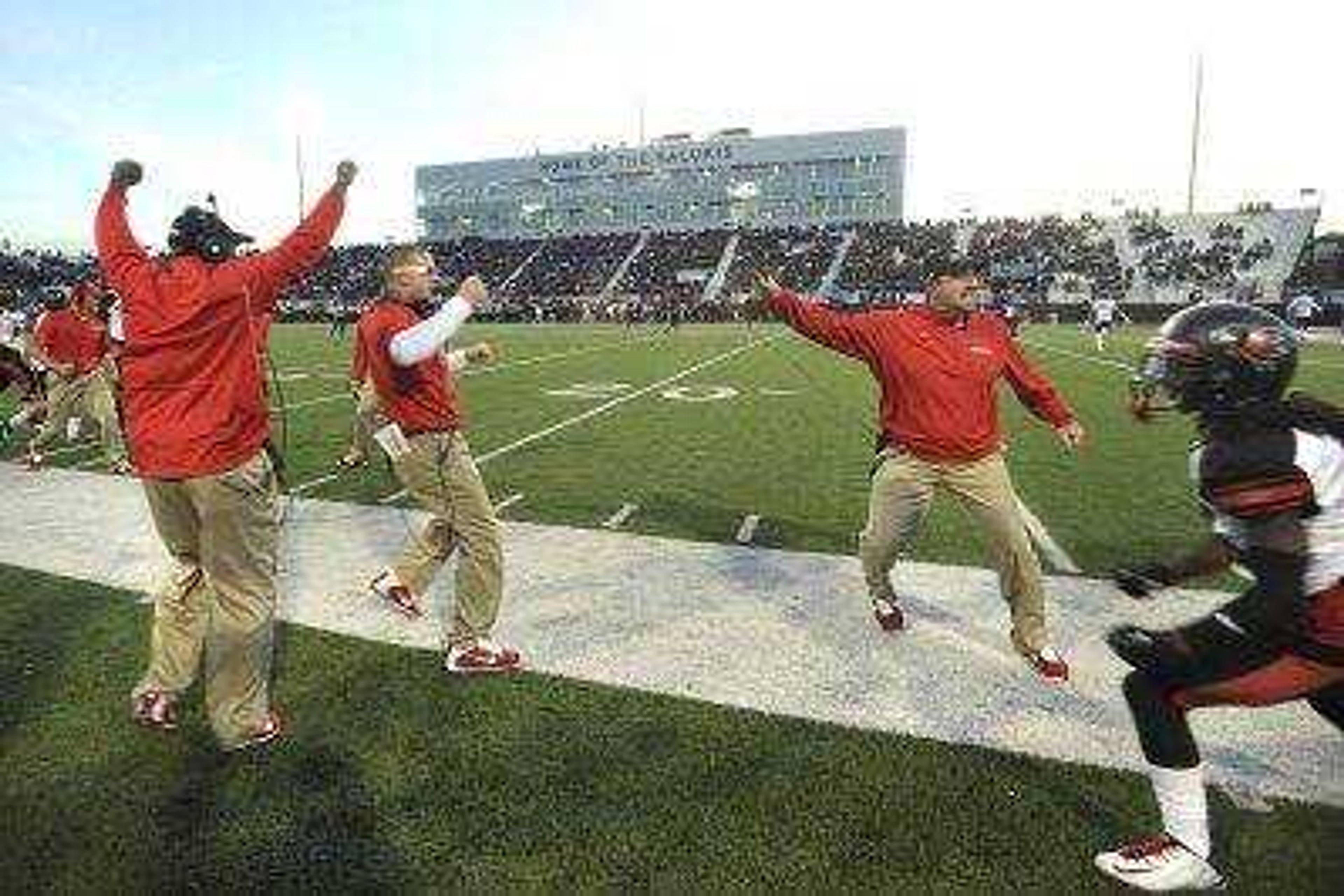 FRED LYNCH ~ flynch@semissourian.com 
 Southeast Missouri State coach Tom Matukewicz, right, and his staff celebrate after cornerback Tim Hamm-Bey returned an interception 56 yards for a touchdown against Southern Illinois during the second quarter Saturday, Sept. 13, 2014 in Carbondale, Ill.