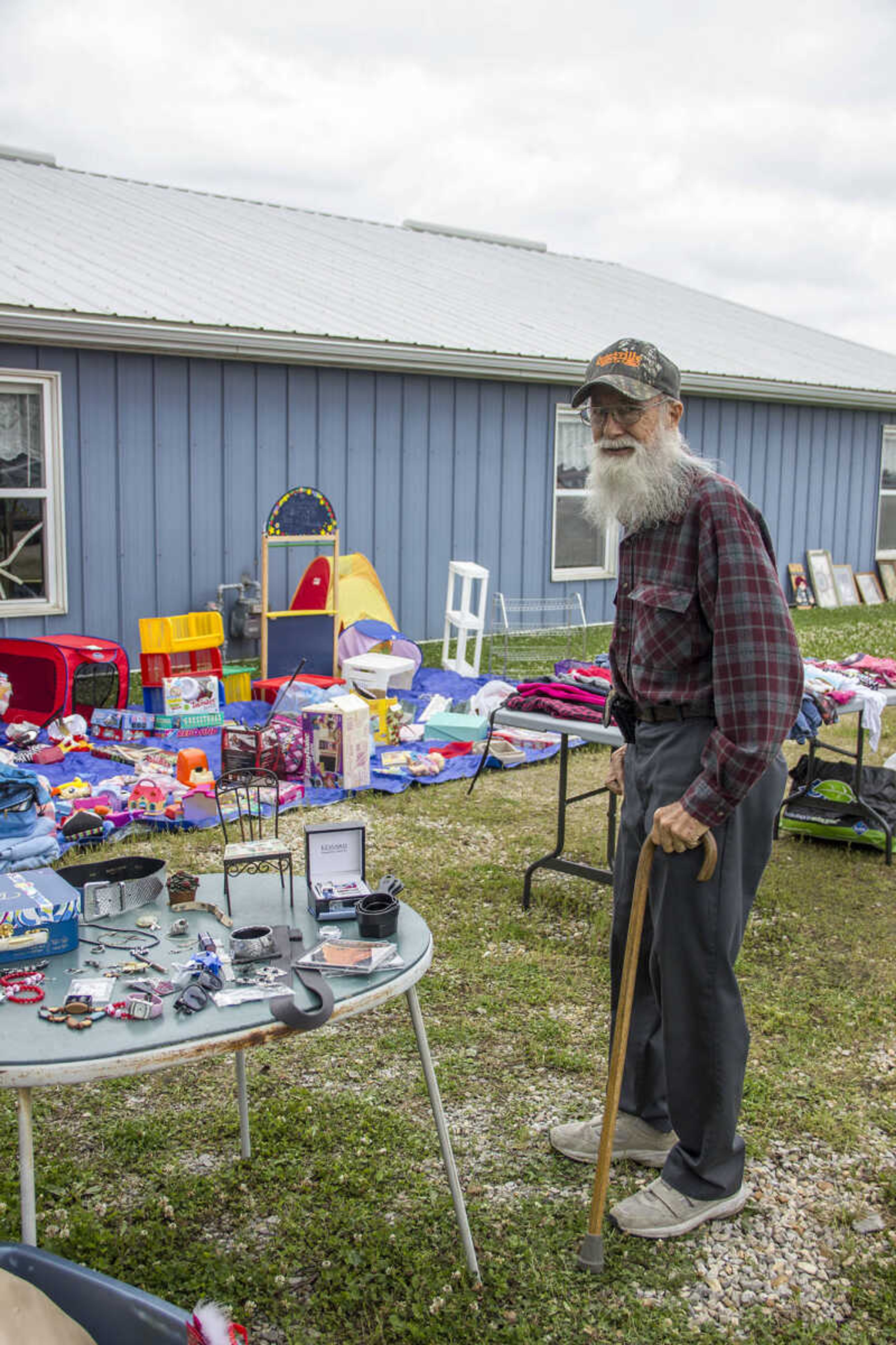 CAROL KELLISON ~ photo@semissourian.com

Paul Brown poses beside a table of items for sale at the 100-mile yard sale on Thursday May 22, 2015 in Advance, Missouri.