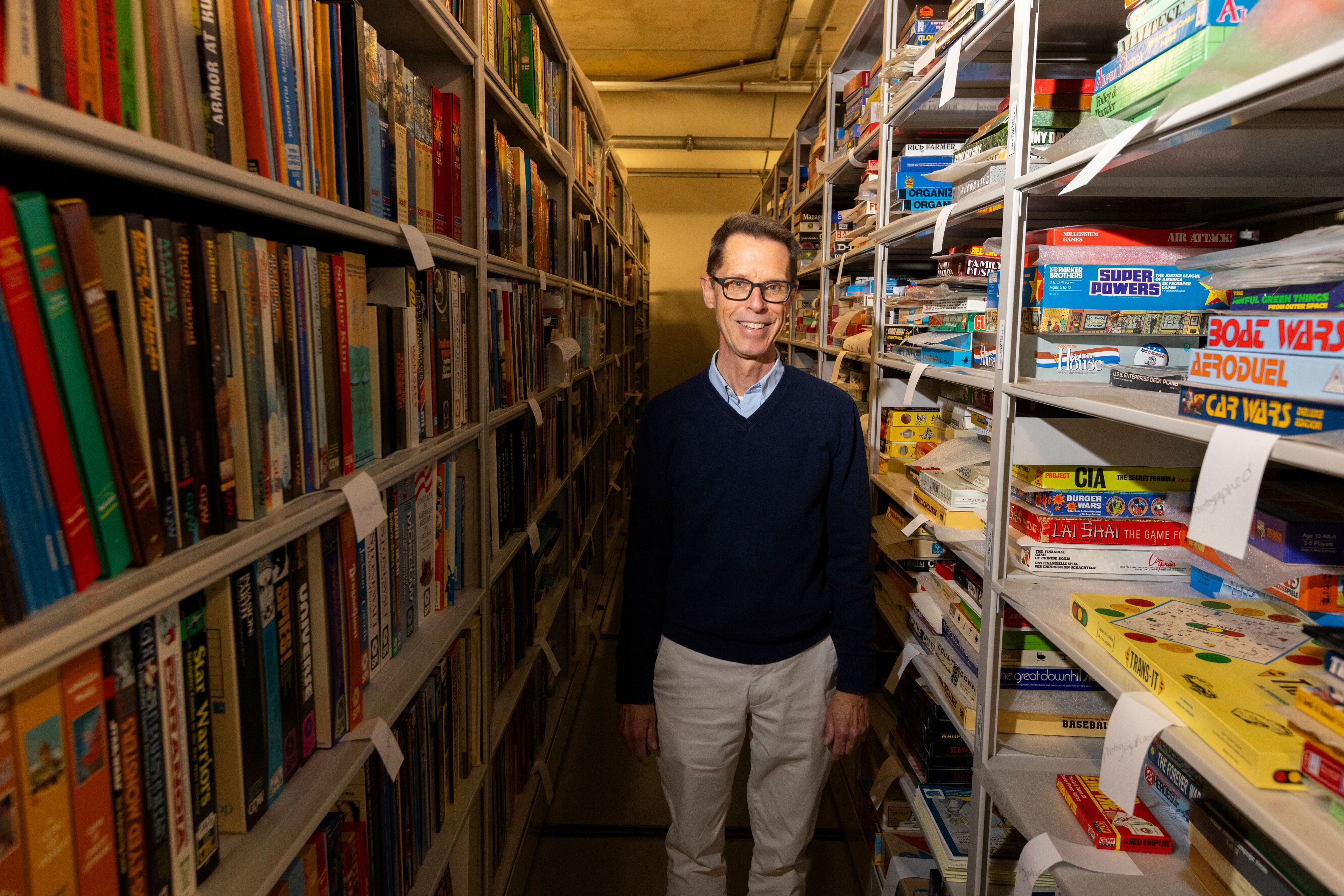 Christopher Bensch, chief curator at The Strong National Museum of Play, stands among shelves of toys and games in a storage area below the museum, Tuesday, Oct. 15, 2024, in Rochester, N.Y. (AP Photo/Lauren Petracca)