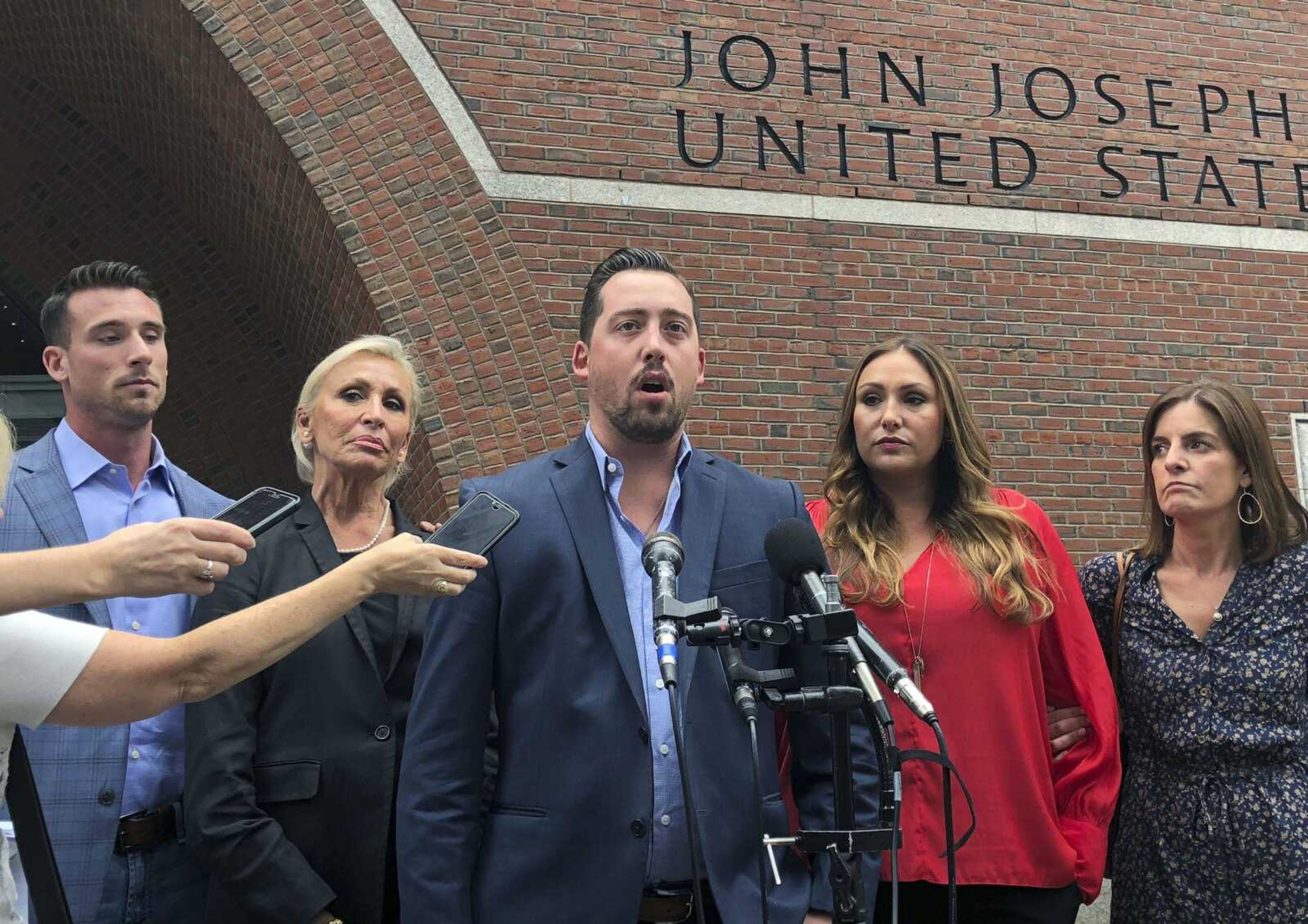 Michael DiSarro speaks alongside family members outside federal court following the sentencing of Francis "Cadillac Frank" Salemme to life in prison Thursday in Boston.