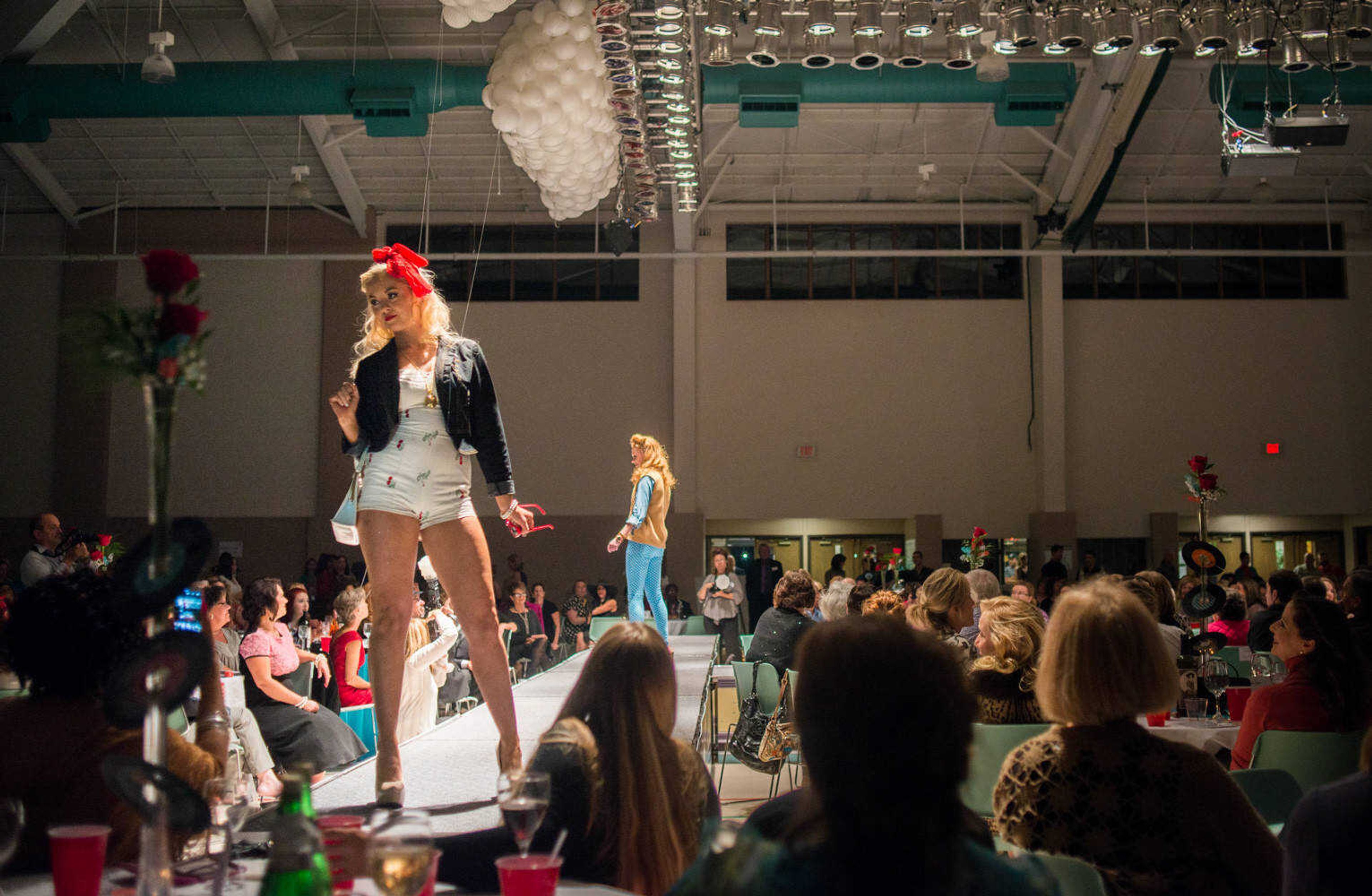 AARON EISENHAUER ~ photos@semissourian.com
Emilie Davis, pauses at the edge of the runway as she models vintage fashions during the fifth annual VintageNOW fashion show, a fundraiser for Safe House for Women, at the Osage Centre on Friday, October 17, 2014.