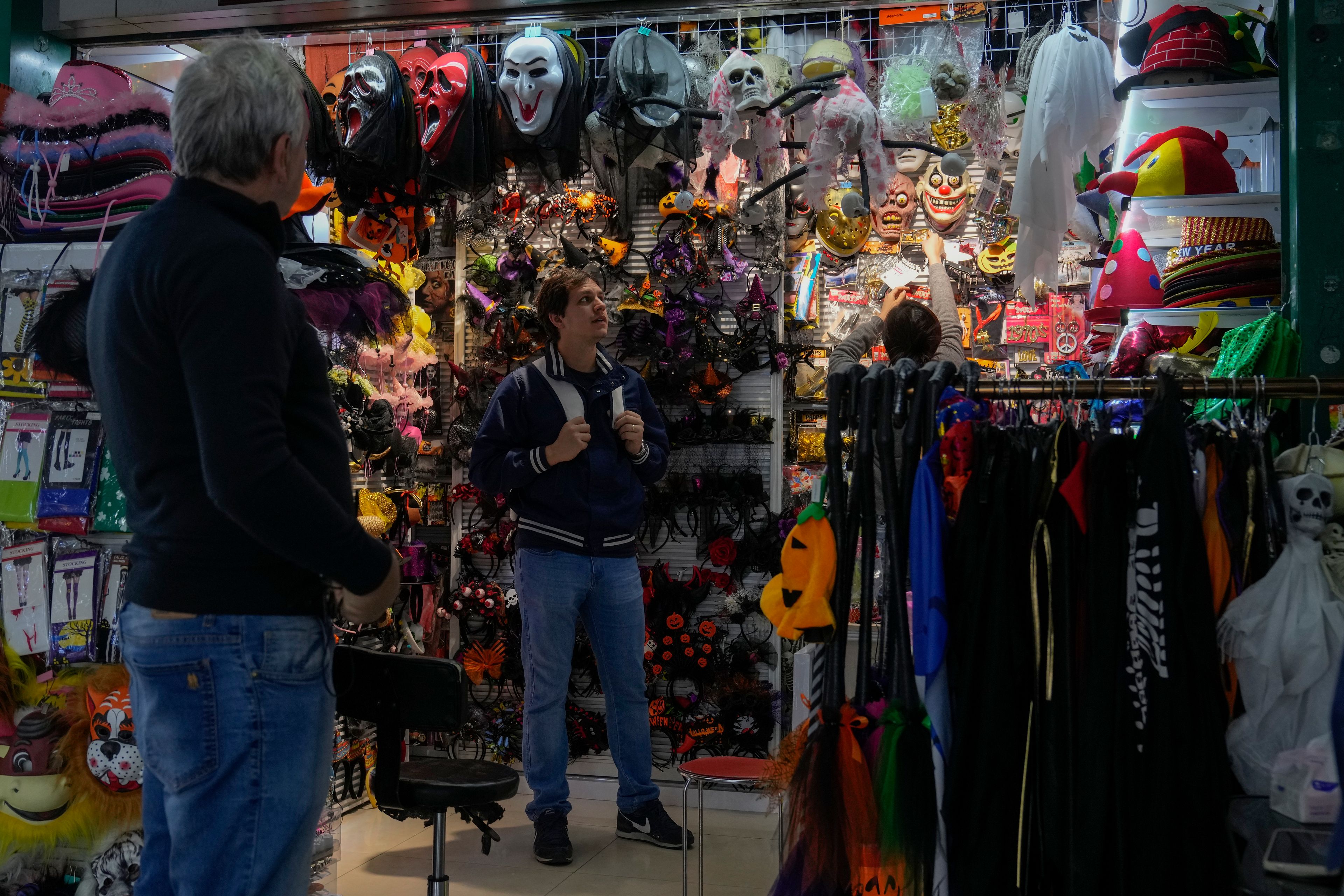 Foreigners shop at a store selling variety masks and costumes at the Yiwu wholesale market in Yiwu, east China's Zhejiang province on Nov. 8, 2024. (AP Photo/Andy Wong)