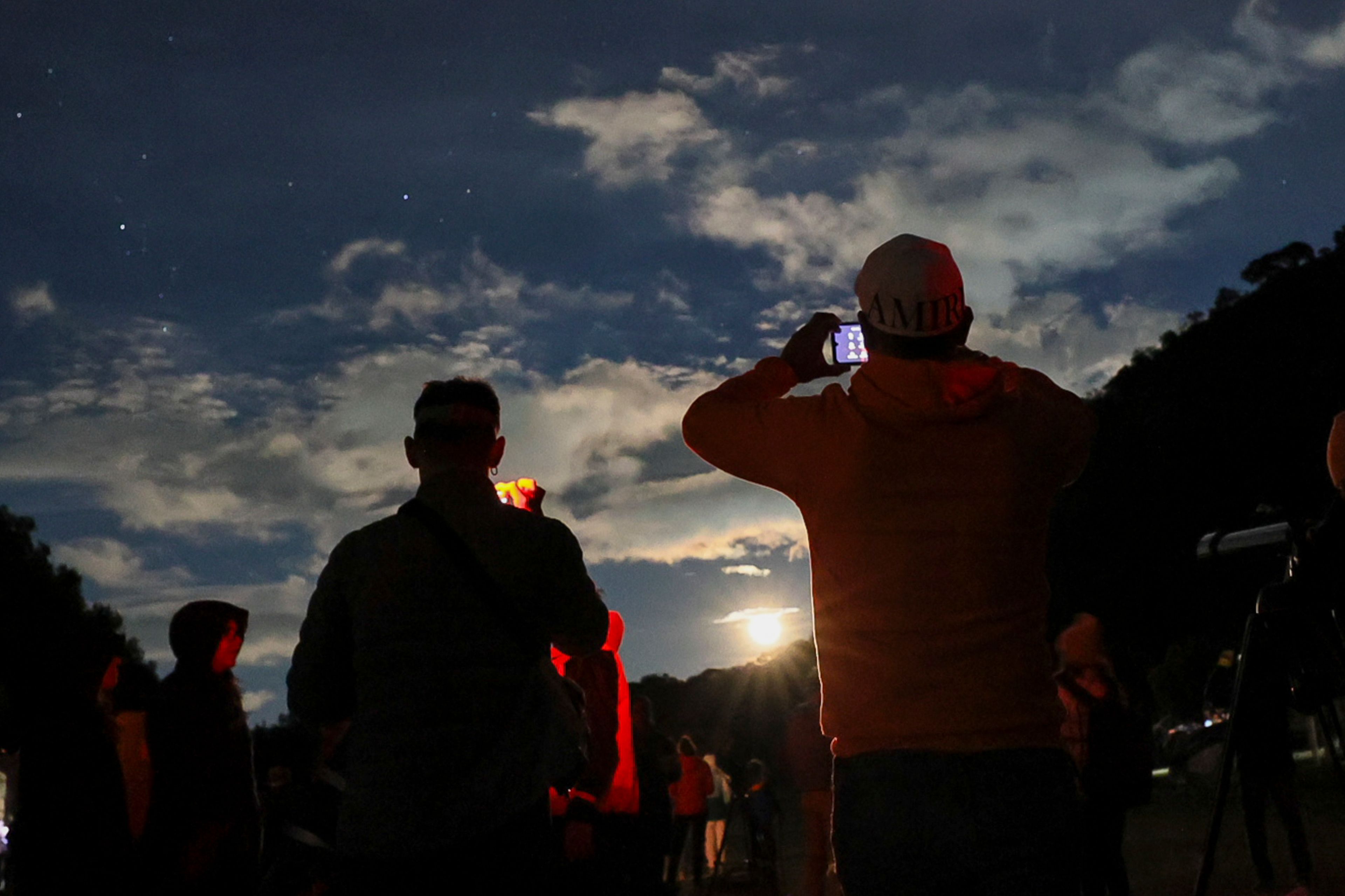 People take photos of the sky at a stargazing and comet-watching gathering at Joya-La Barreta Ecological Park in Queretaro, Mexico, Saturday, Oct. 19, 2024. (AP Photo/Ginnette Riquelme)