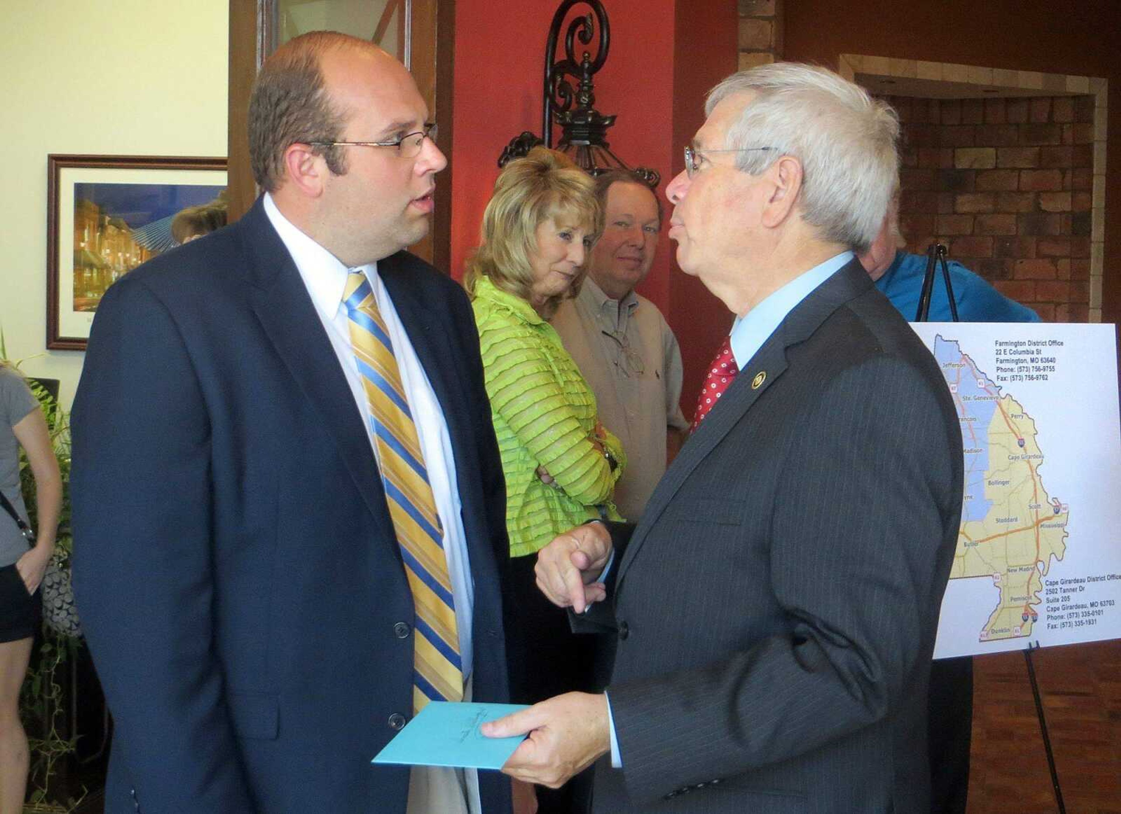 U.S. Rep. Jason Smith, left, chats with state Sen. Wayne Wallingford during a ribbon-cutting ceremony Friday at the opening of Smith&#8217;s congressional office in Cape Girardeau. Although Smith has been in Washington since early June, his former 120th House District in Missouri remains vacant. (ERIN RAGAN)