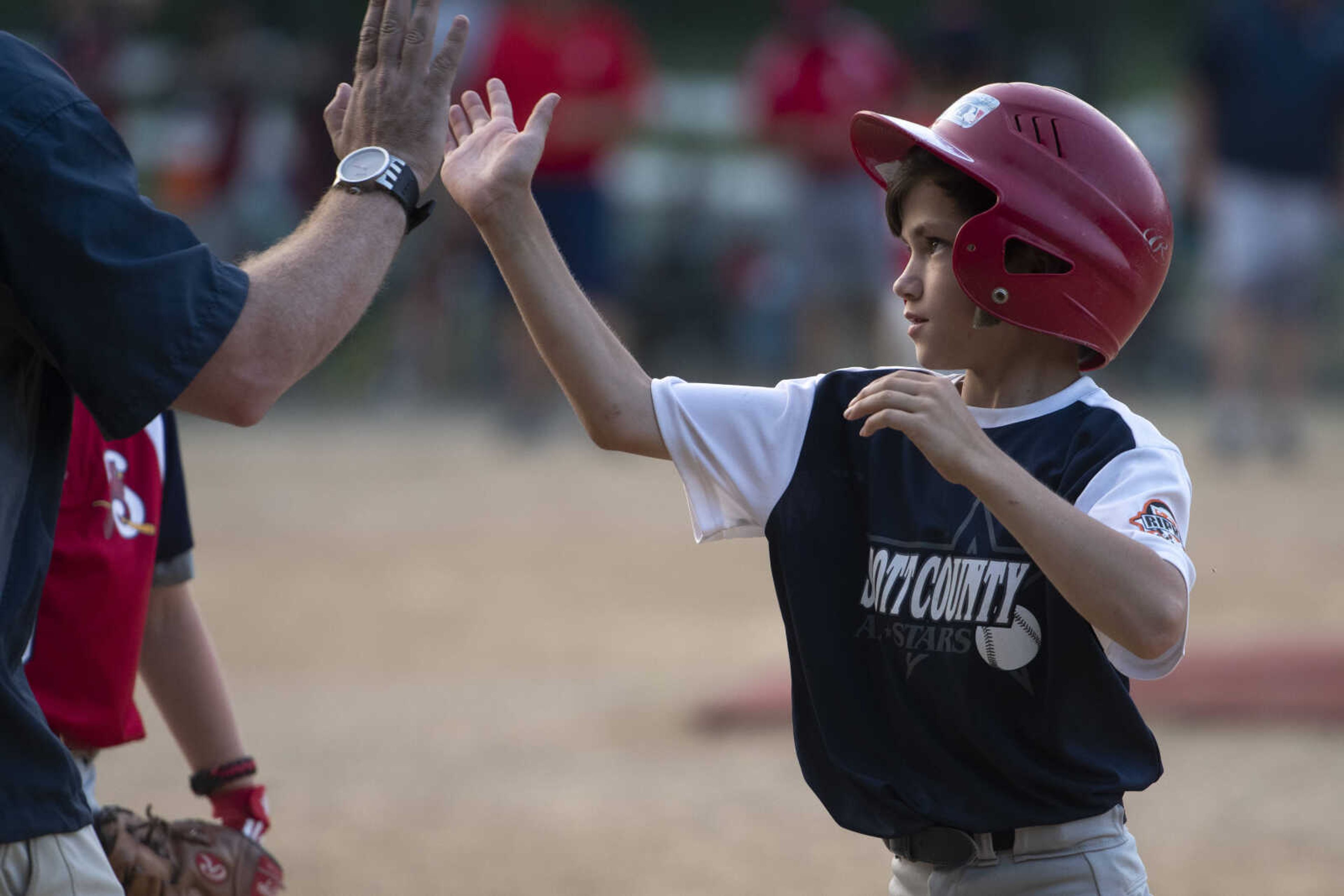 Colton Landewee of the Scott County All-Stars high fives a coach during the team's 5-2 victory over the SEMO Cardinals in the championship game of the 2019 Kelso 11U Showdown on Sunday, June 2, 2019, in Kelso.