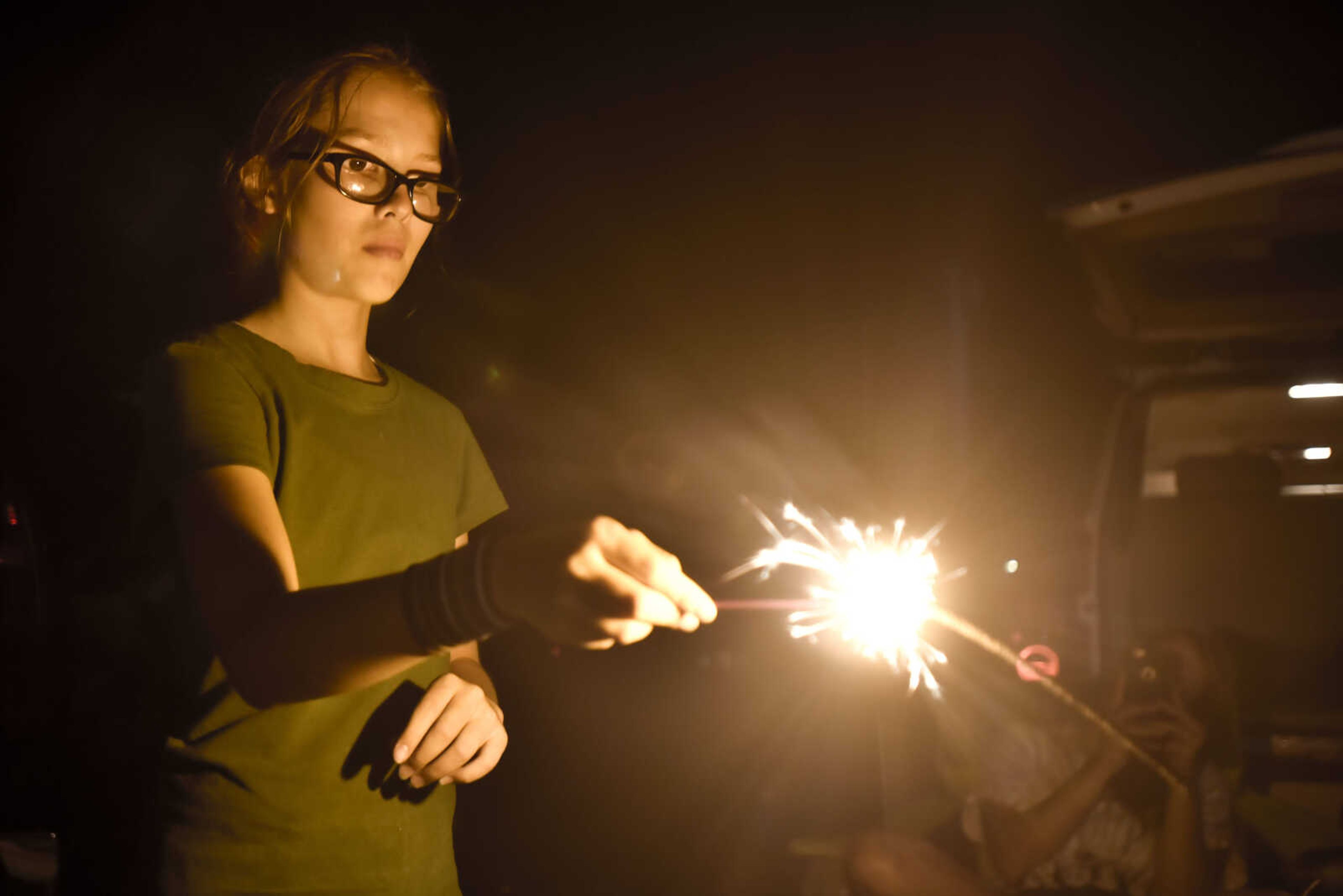 Joslyn Wingo, 9, watches a sparkler burn Tuesday, July 3, 2018, at Cape County Park North in Cape Girardeau.