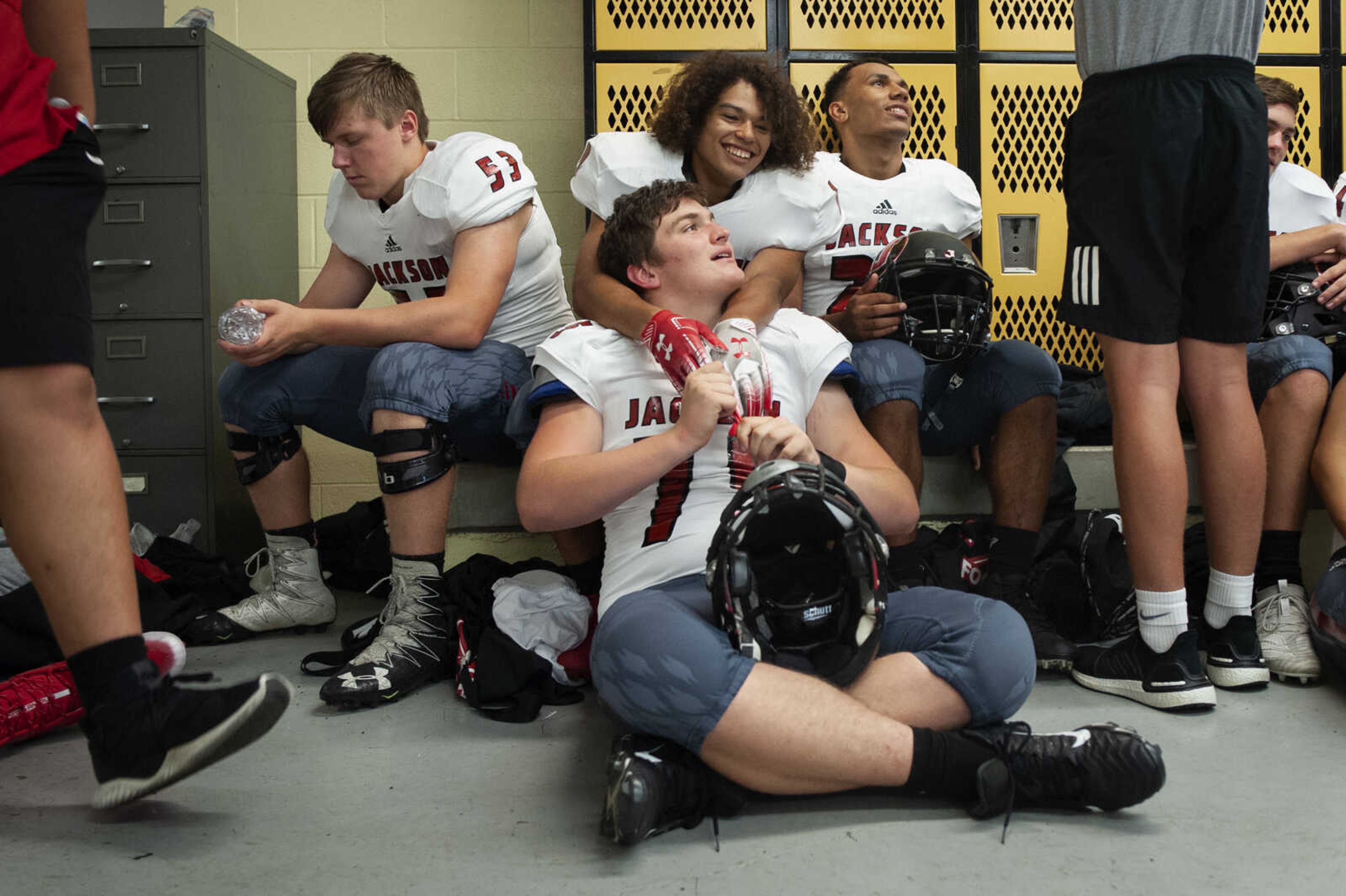 Top row from left: Jackson's Nathan Harrison (53), Joshua Wehrenberg (19) and Javin Hitchcock (27) wait for the start of the game with Mark Brakhane (75), bottom center, before the Jackson Indians' 35-14 victory over Farmington on Friday, Oct. 4, 2019, in Farmington, Missouri.