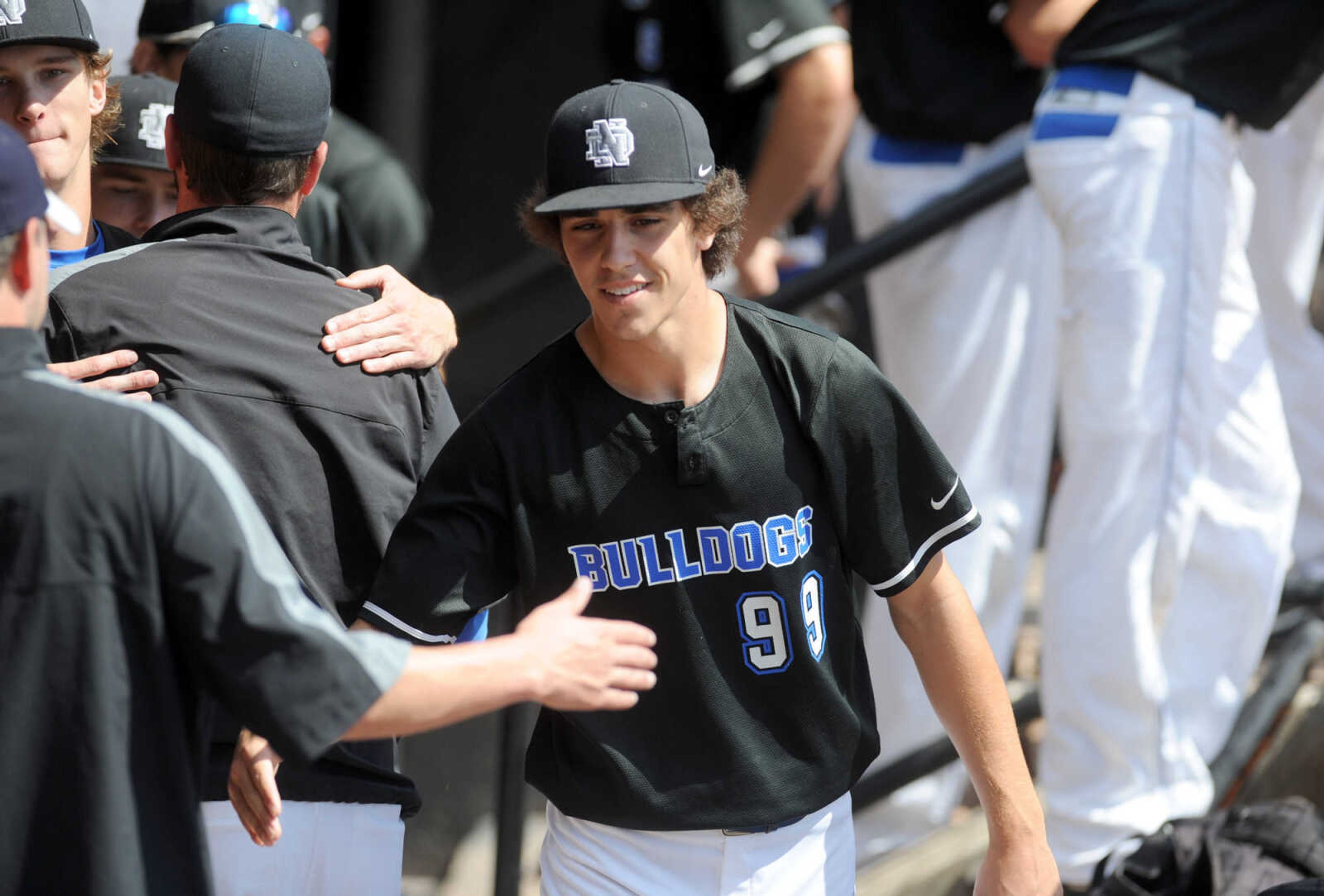 Notre Dame's Adam Pope hands out a high-five in the dugout during the Class 4 semifinal against Smithville, Friday, June 5, 2015, in O'Fallon, Missouri. Notre Dame won 13-3 in six innings. (Laura Simon)