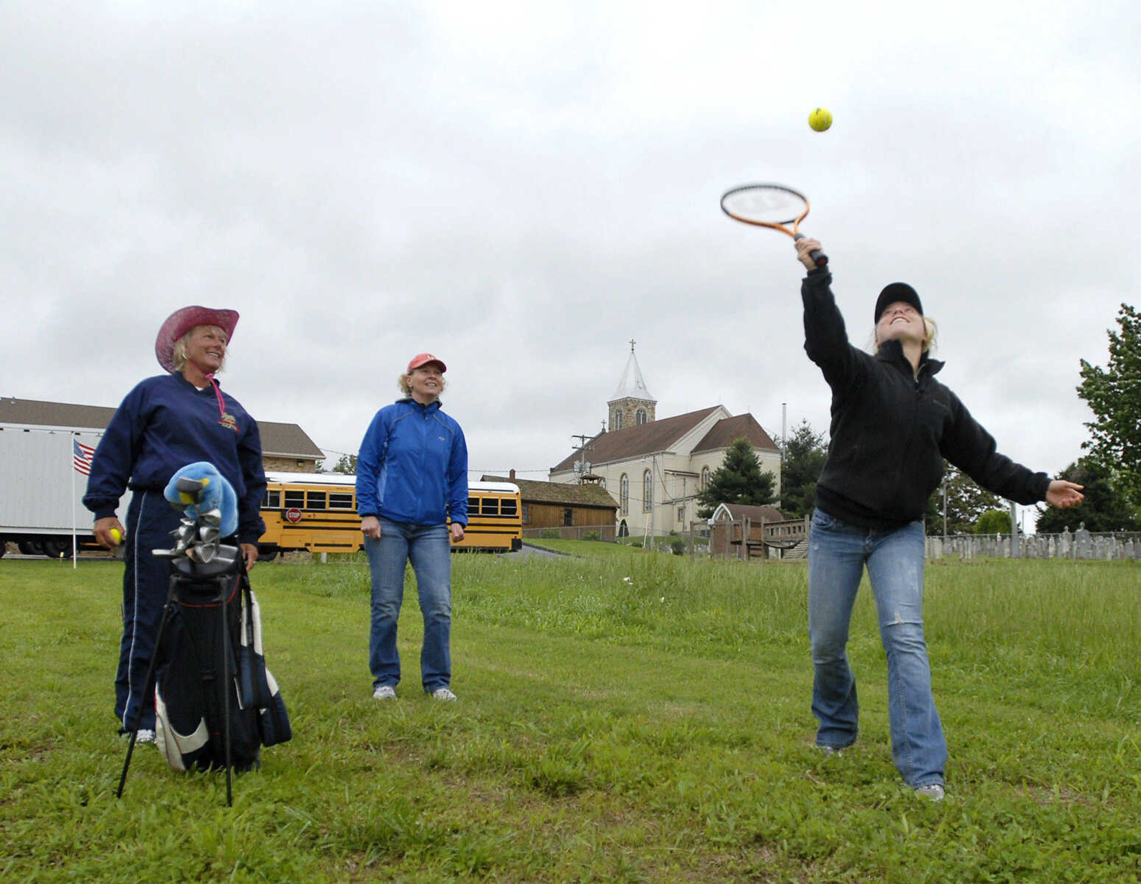 KRISTIN EBERTS ~ keberts@semissourian.com

Hollie Adelmund, right, uses a tennis racket to hit the ball as teammates Jane Slaten, left, and Jill Adelmund, center, watch during the Kow Pasture Klassic at Schlinder's Tavern in New Hamburg, Mo., on Saturday, May 14, 2011. Proceeds from the event benefit the Kenny Rogers Children's Center and the Missouri Veterans Home.