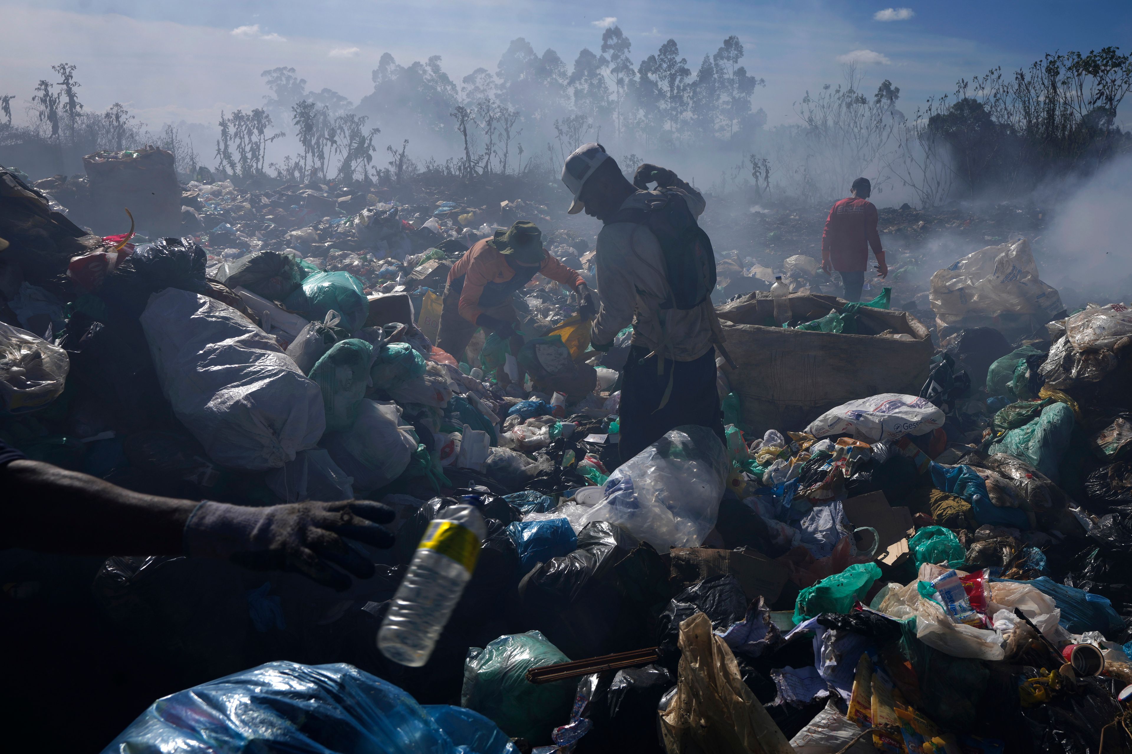 FILE- Recyclable collectors work at the Lixao open-air dump in Santo Antonio do Descoberto, Goias state, Brazil, June 4, 2024. (AP Photo/Eraldo Peres, File)