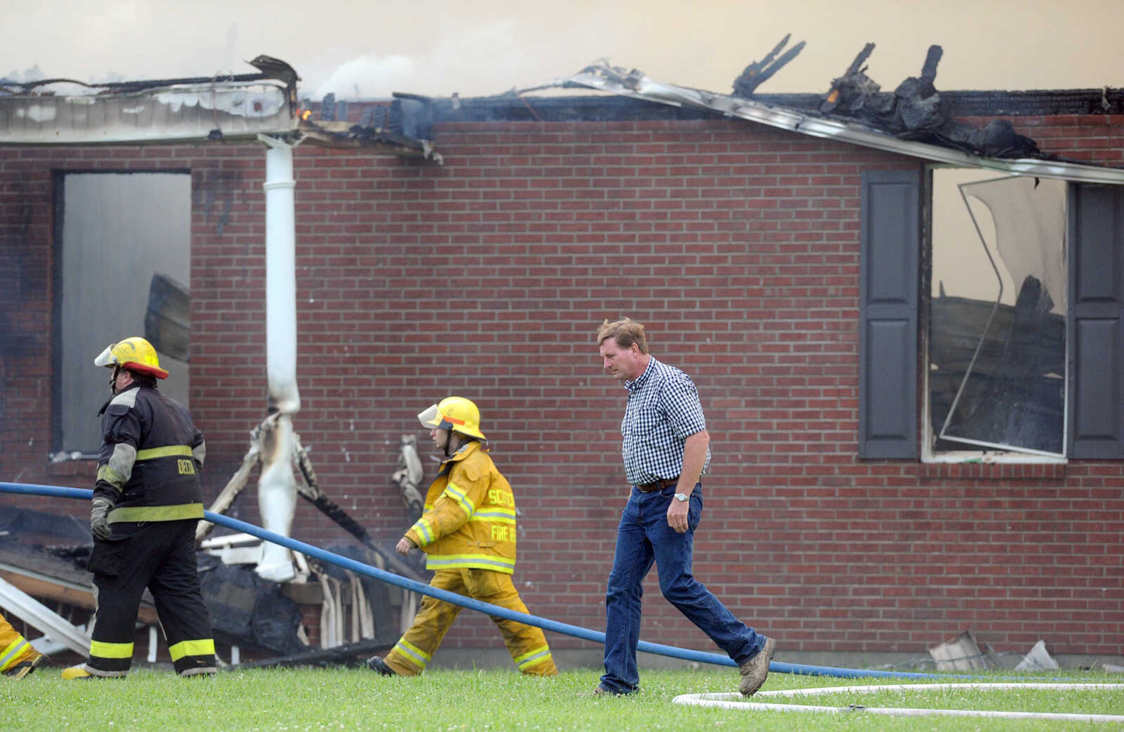 LAURA SIMON ~ lsimon@semissourian.com

David Landewee circles the perimeter of his house as firefighters from Delta, Scott City, Chaffee and New Hamburg/Benton/Commerce battle the fire engulfing his house off County Road 204 in Scott County Wednesday afternoon, July 23, 2014.