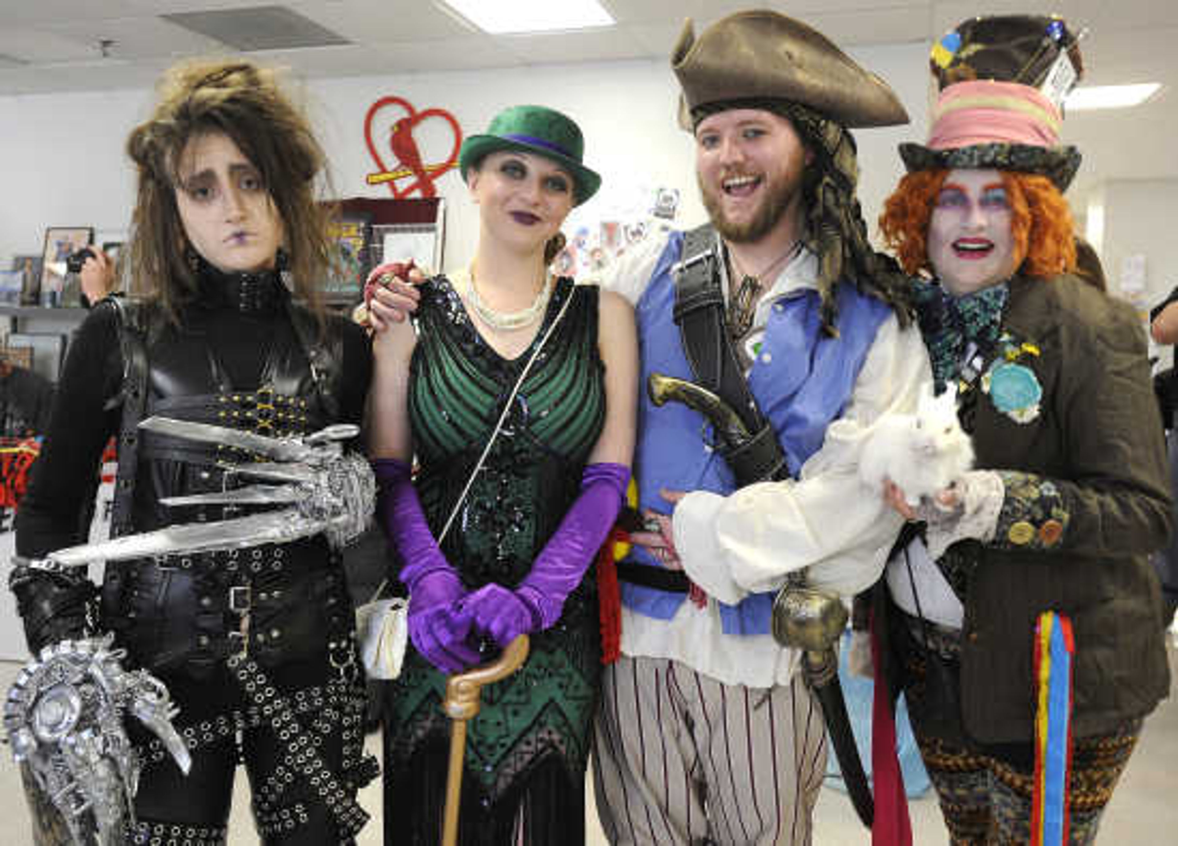 Rachel Bagot, left, as Edward Scissorhands, Amanda Camp as a 1920s Riddler, Trevor Camp as a Sea of Thieves pirate, and Lisa Bagot as the Mad Hatter, pose for a photo Saturday, April 21, 2018 at Cape Comic Con at the Osage Centre.