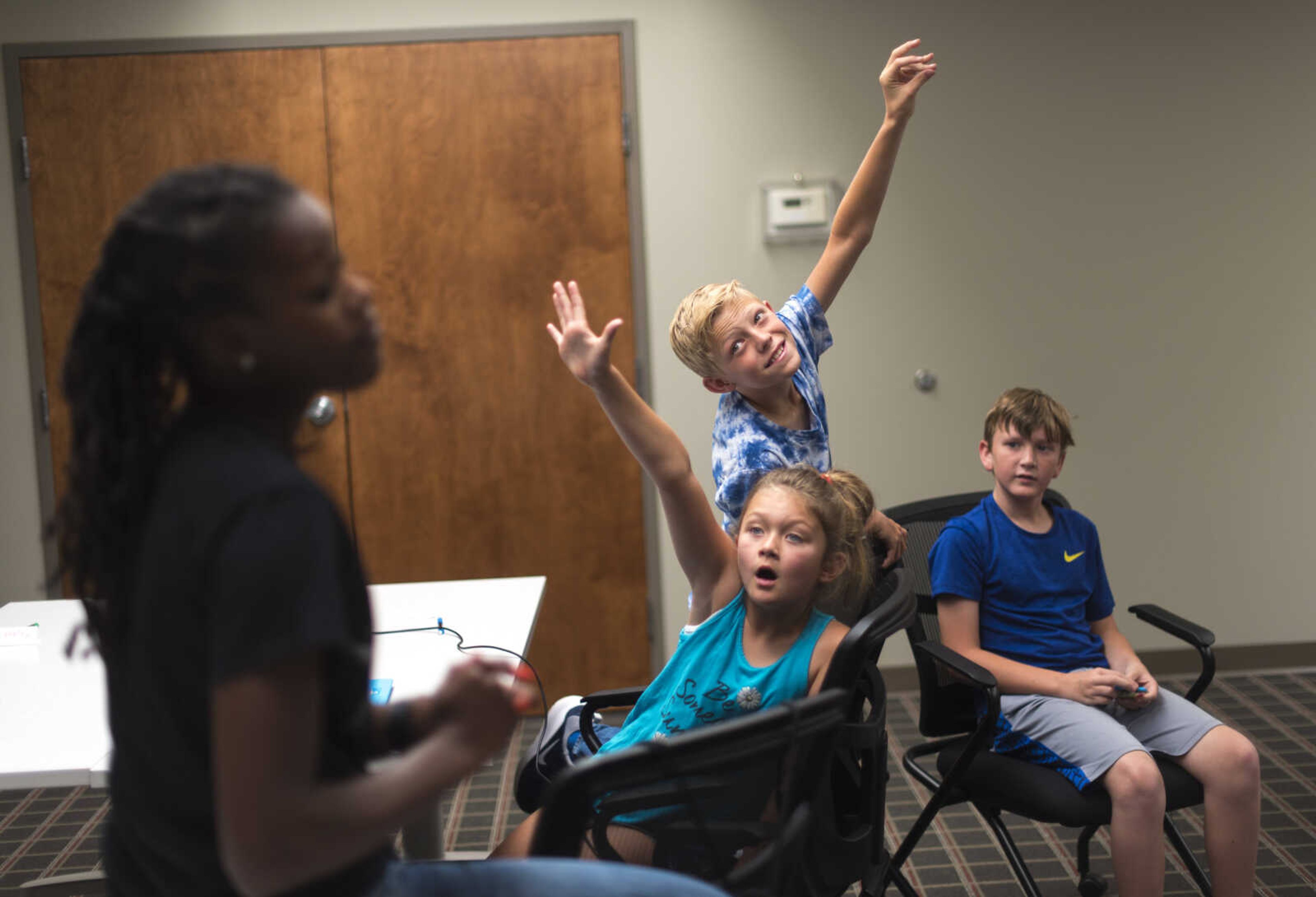 Mason Landgraf and Ava Wessell raise their hands while instructor Andrea Cox asks a question during the Code Camp: Coding with The Finch with the Marquette Technology Institute Monday, July 17, 2017 in Cape Girardeau.