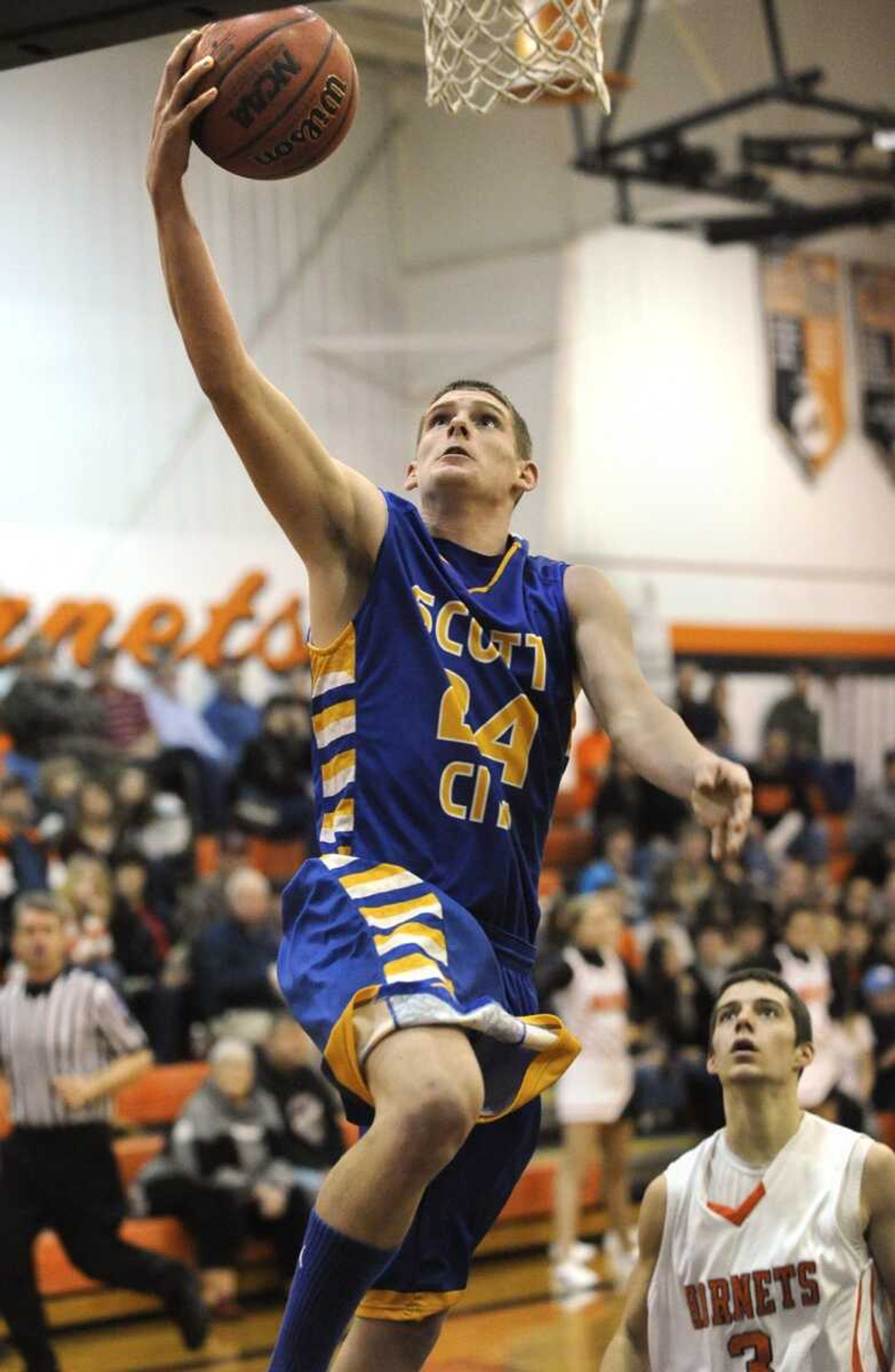 Scott City's Zach Cotner drives to the basket on a fast break as Advance's Tyler Middleton looks on during the third quarter Friday in Advance, Mo. (Fred Lynch)