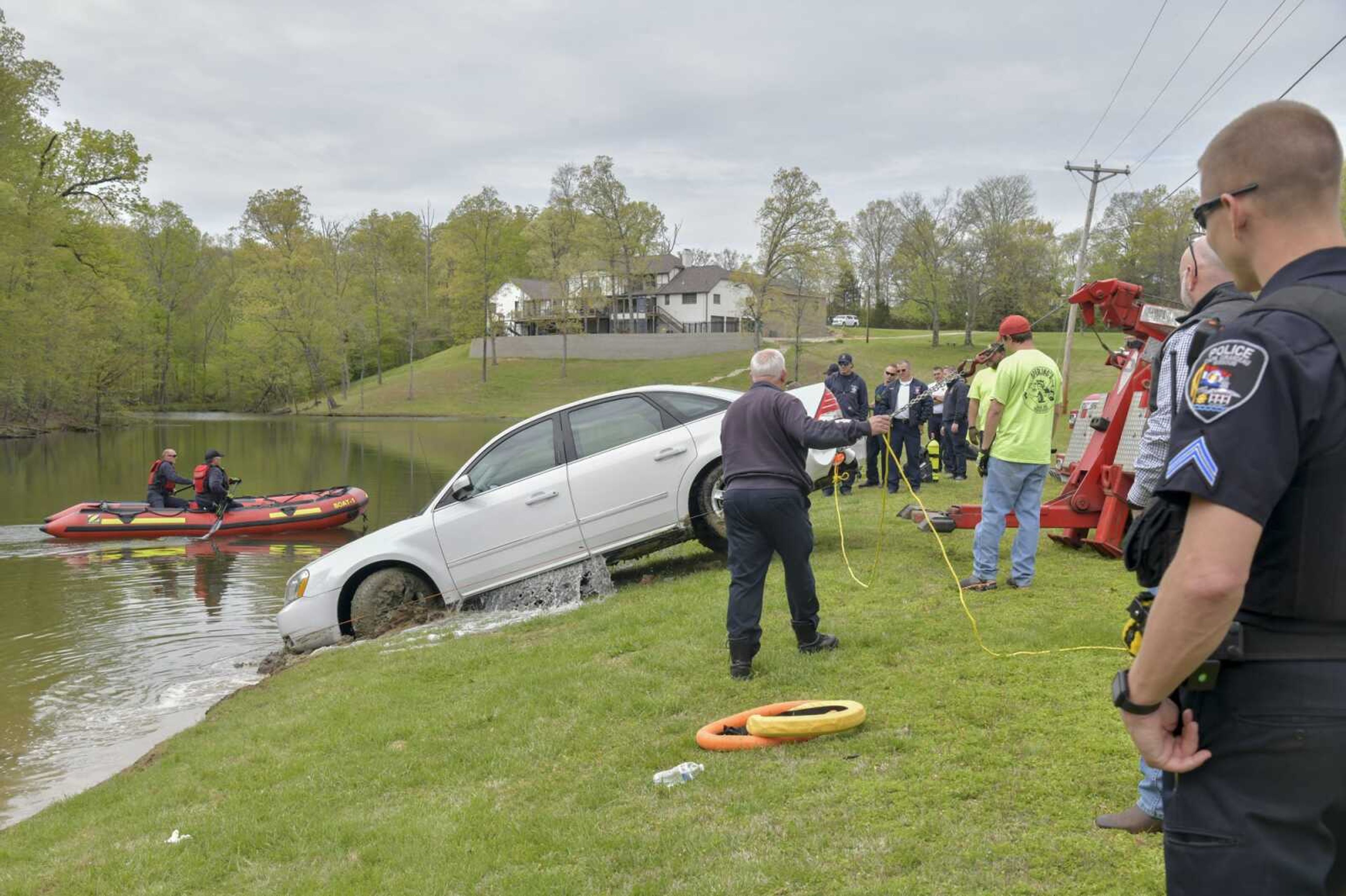 The submerged car leaks water as it is towed out of Little Ponderosa Lake near the intersection of Prospect Drive and Scenic Drive on Friday, April 16, 2021.