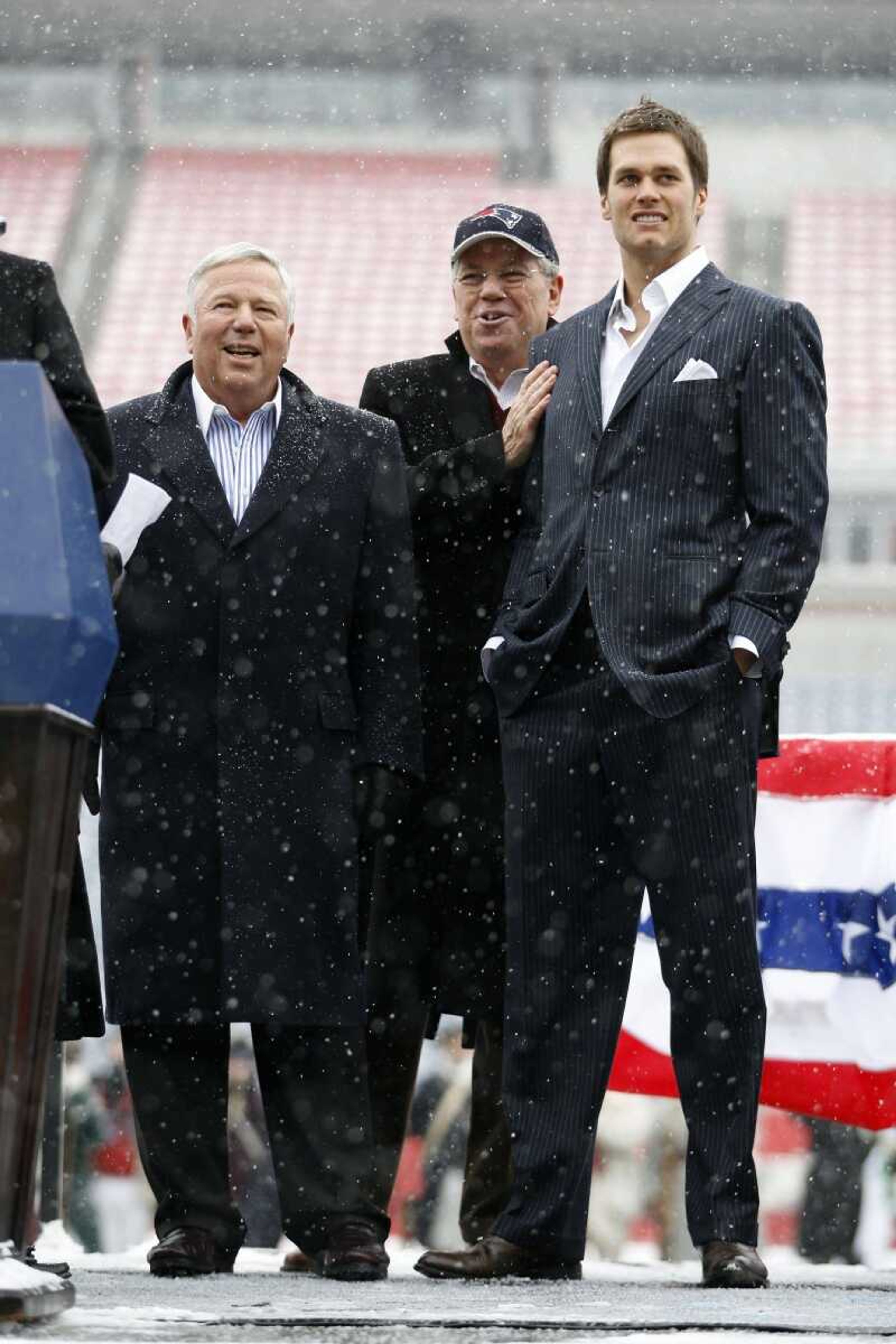 Rhode Island Gov. Don Carcieri, center, greeted New England Patriots quarterback Tom Brady, right, along with team owner Robert Kraft during Sunday's rally at Gillette Stadium in Foxborough, Mass. (<b>STEW MILNE</b>Associated Press)