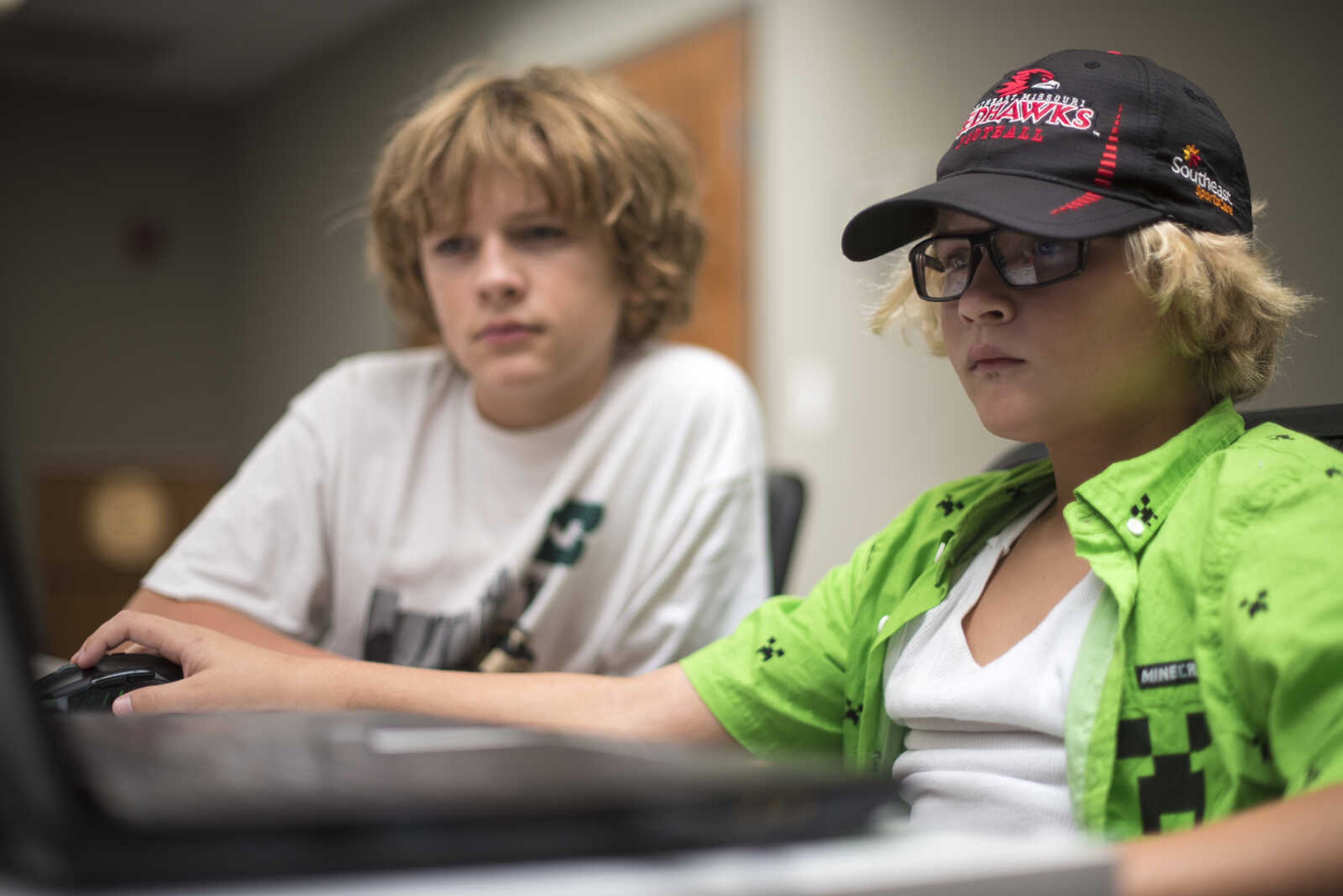 Creighton Edmundson, left, and his brother Wiley Edmundson, right, go over functions for their robot "The Finch" during the Code Camp: Coding with The Finch with the Marquette Technology Institute Monday, July 17, 2017 in Cape Girardeau.