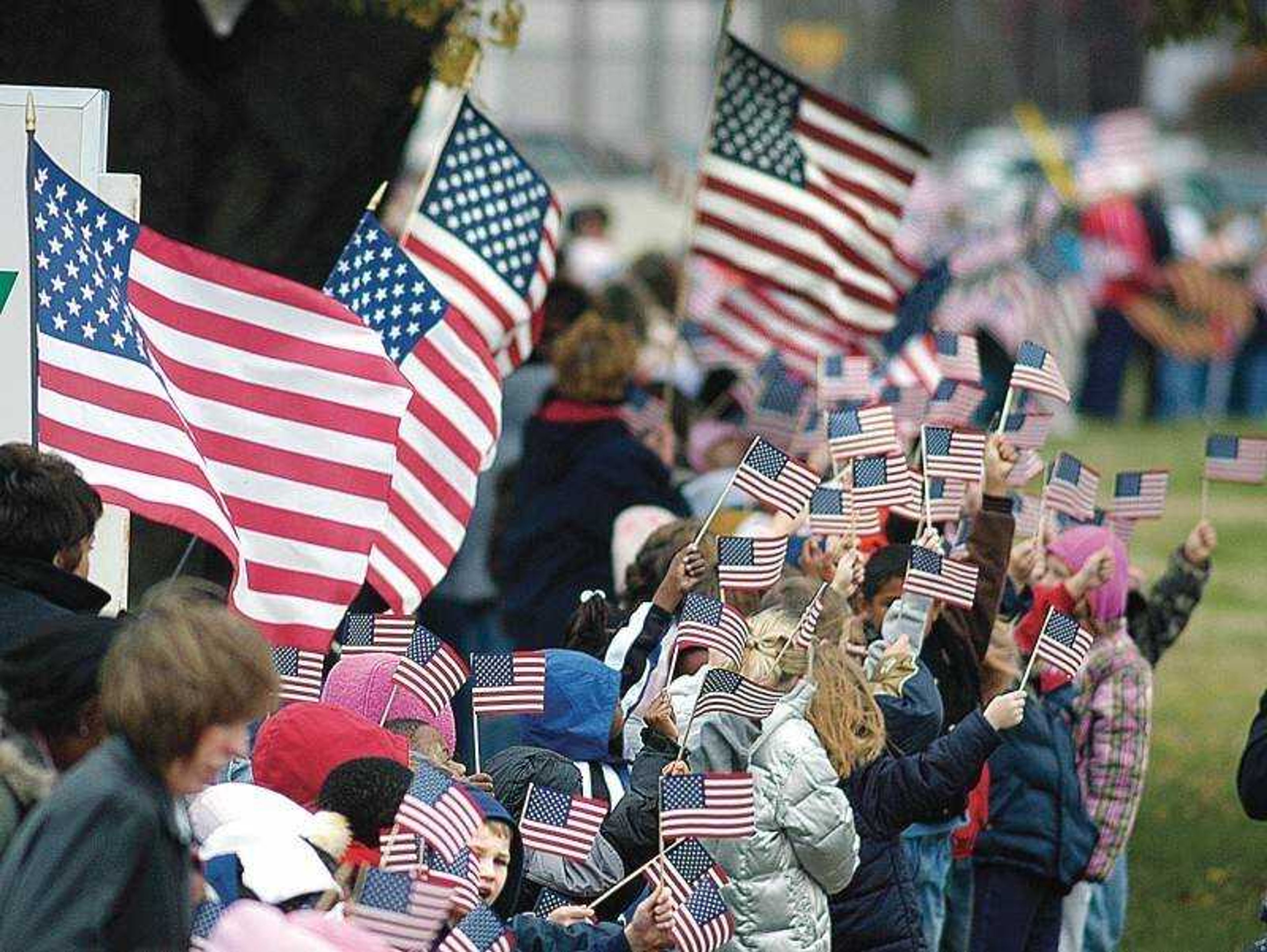 Students and faculty of New Madrid Elementary School stood along the road to wave flags Wednesday as the funeral procession for 1st Lt. Amos Camden Bock passed by. (Diane L. Wilson)<br>
[<a href="http://semissourian.com/gallery/bock-funeral/">Browse a photo gallery]</a>