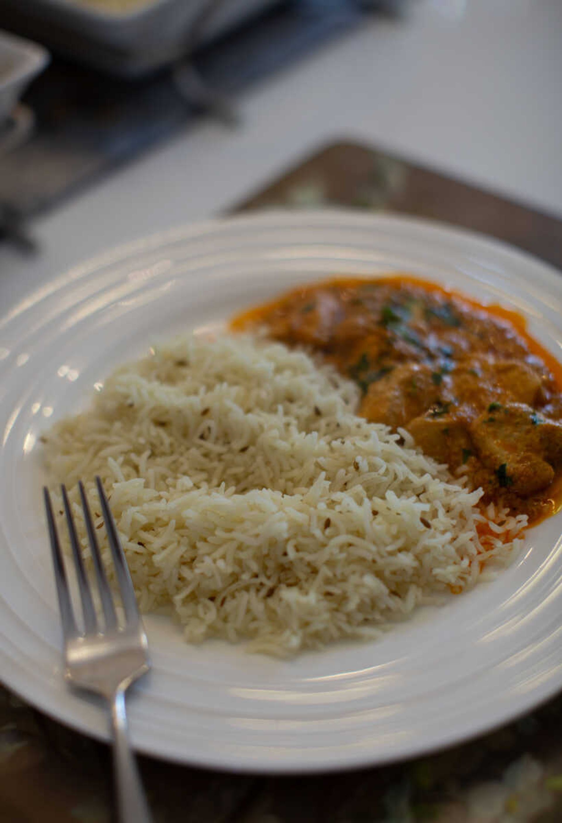 A plate of butter chicken masala sits on Uzma Aziz's dining room table. Aziz says food is important in her culture, and it is used as a way to show love to friends, family members and guests.