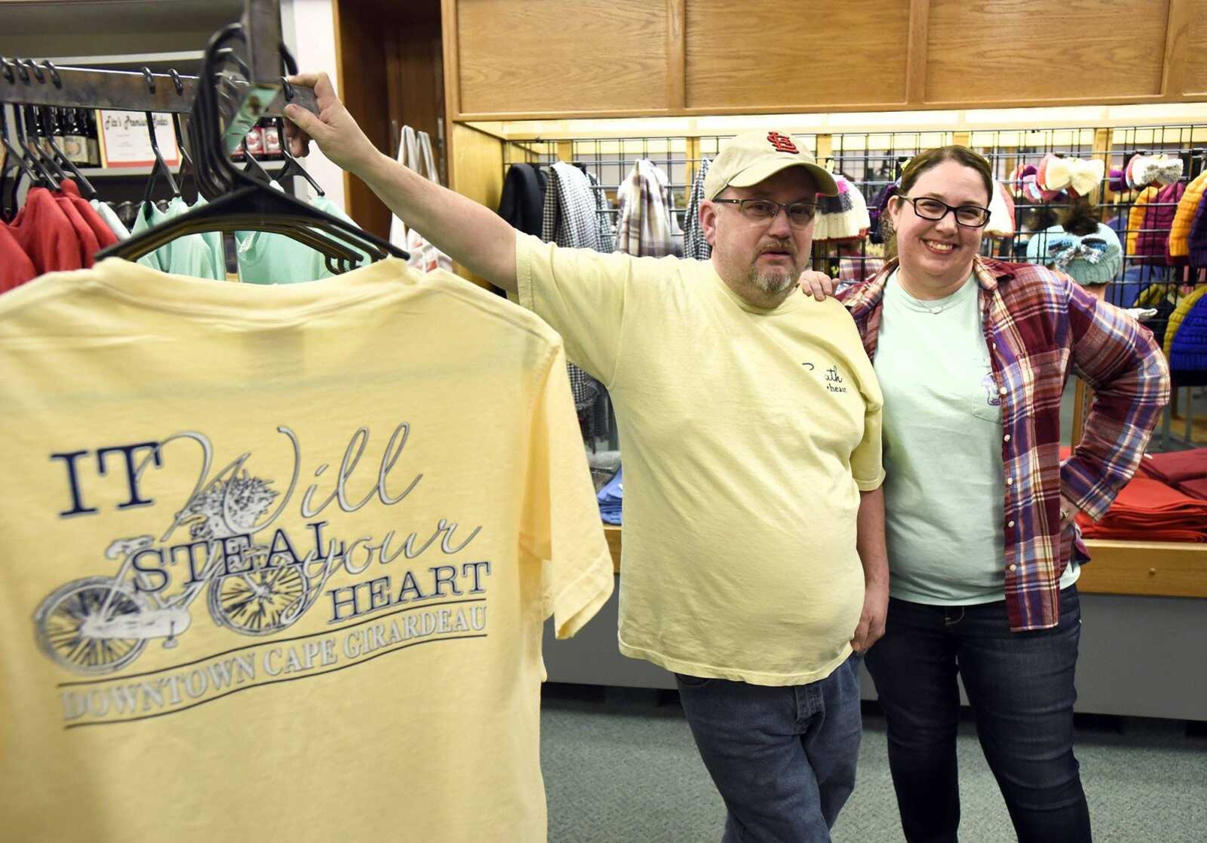 Steve Rector and his fiance Kelli Seabaugh pose for a photo inside their store, Threadz, in downtown Cape Girardeau.