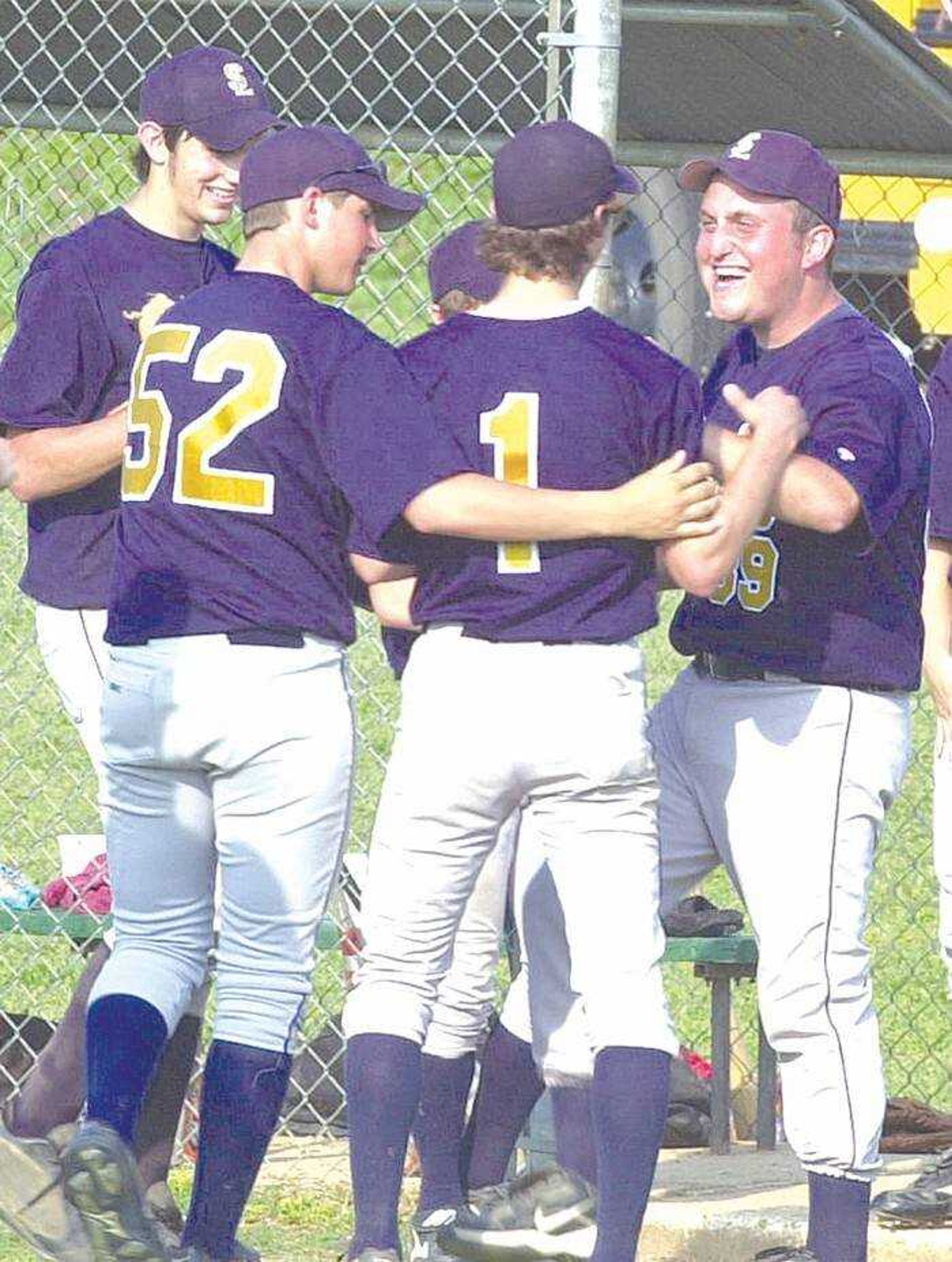 Saxony Lutheran players and coach Lance Limbaugh, right, congratulated Peter Winningham (1) after a 1-2-3 sixth inning Wednesday in the Class 1 sectional game at Thayer. Winningham picked up the win for the Crusaders. (Toby Carrig)