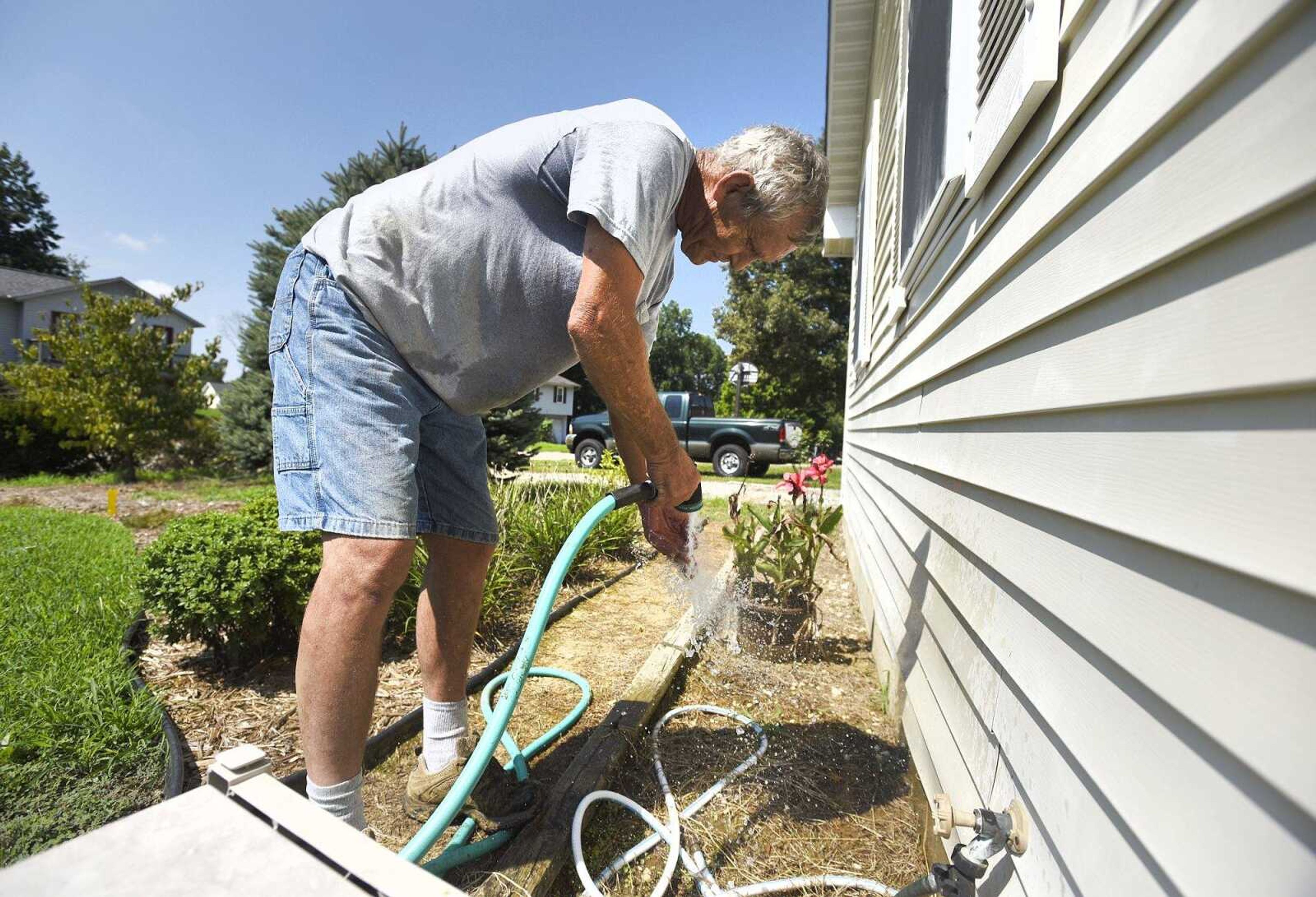 Gary Minor hoses himself off after working in his yard Wednesday in the Hillcrest Subdivision.